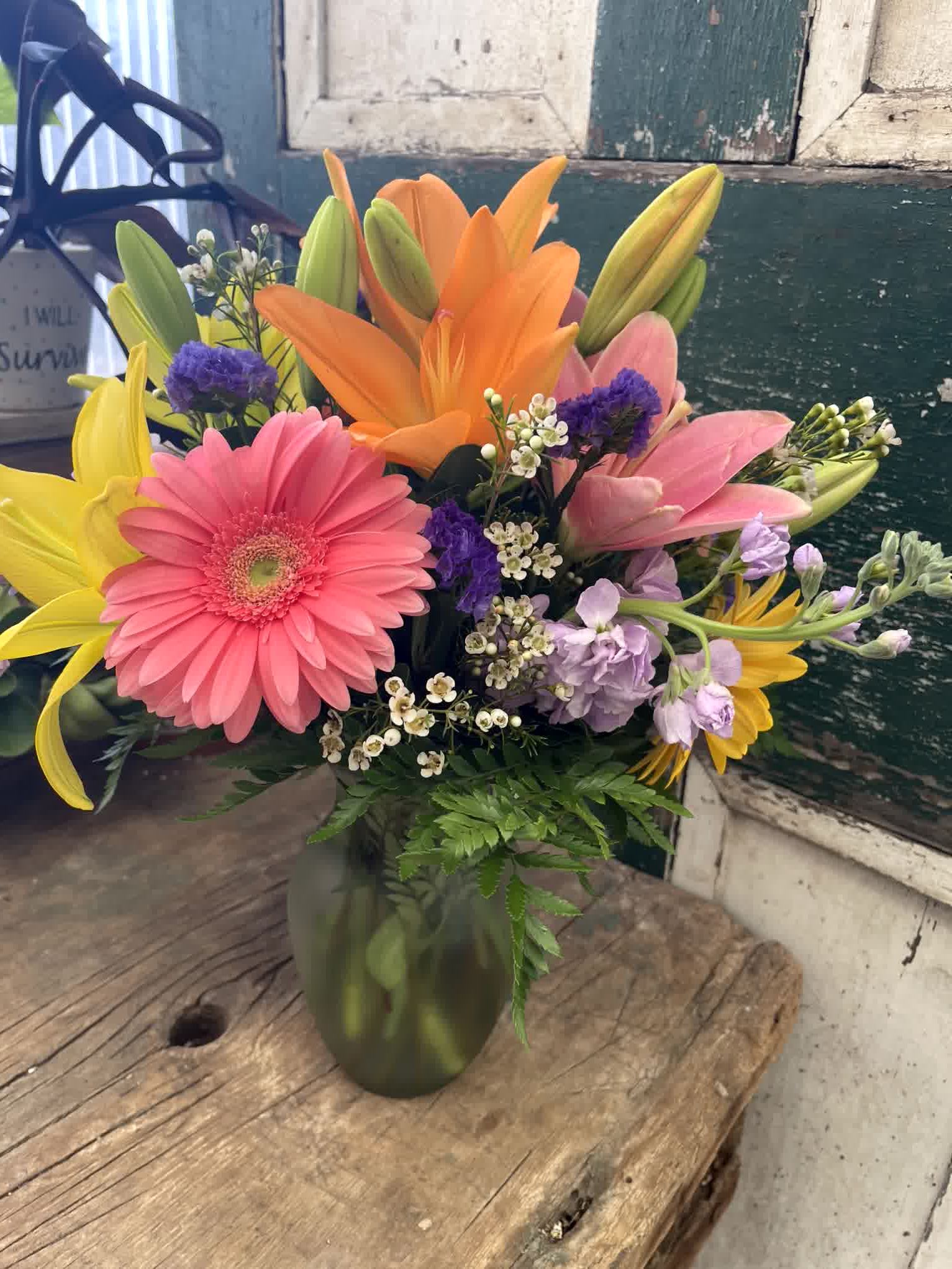 Flirty Floral - Sometimes the simple things in life can bring the most joy – and this flirty mix of pink and peach blossoms, mixed with greenery and presented in a clear glass sweetheart vase – is bright, pretty and perfect for any occasion.