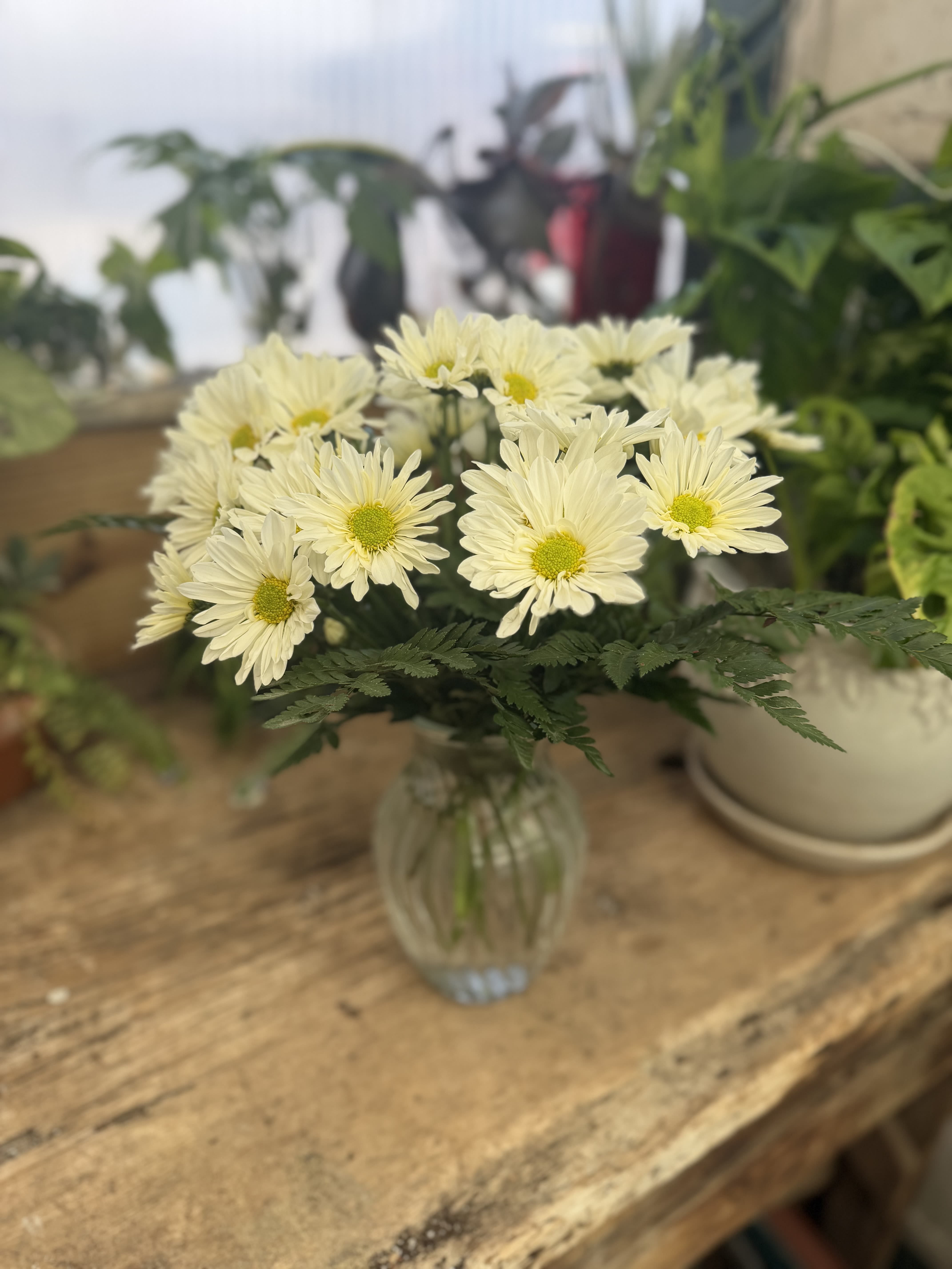 Daisy Daze - A sparkling glass vase overflowing with sun-kissed daisies is a sure-fire way to brighten anyone's day!