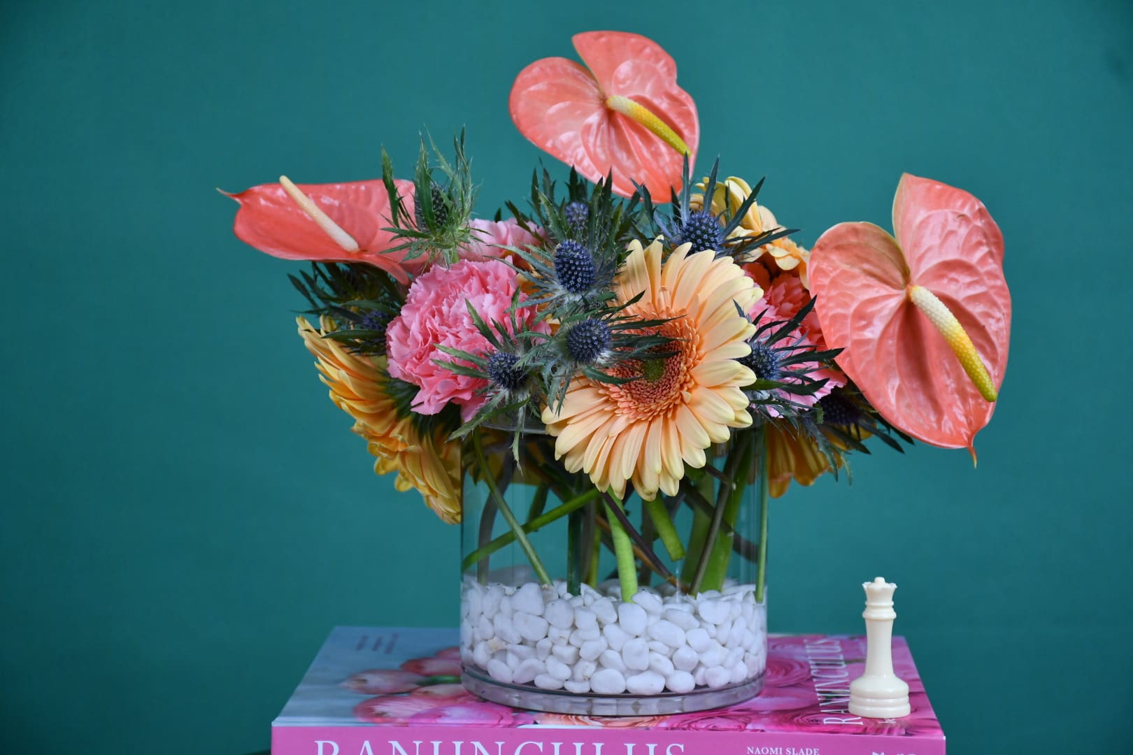 Mixed bouquet in a glass vase with pink anthuriums and peach gerberas