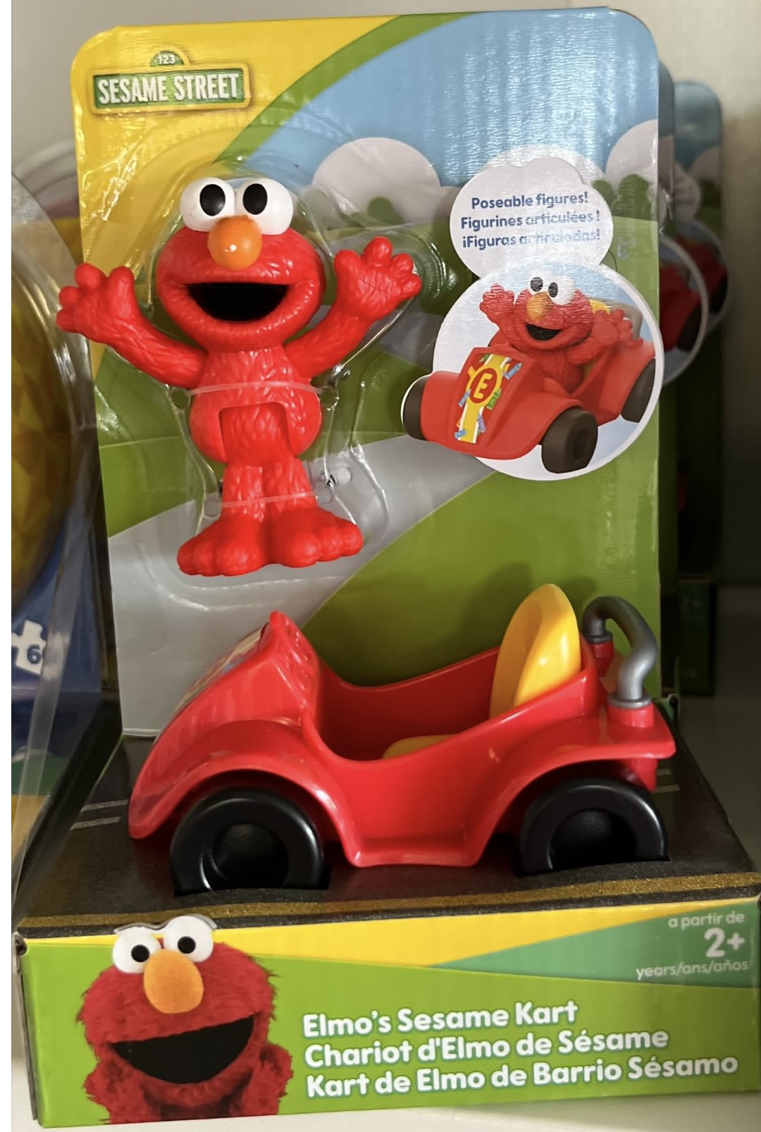 Elmo figurine with a red kart in Sesame Street packaging