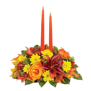 Autumn floral centerpiece with two orange taper candles