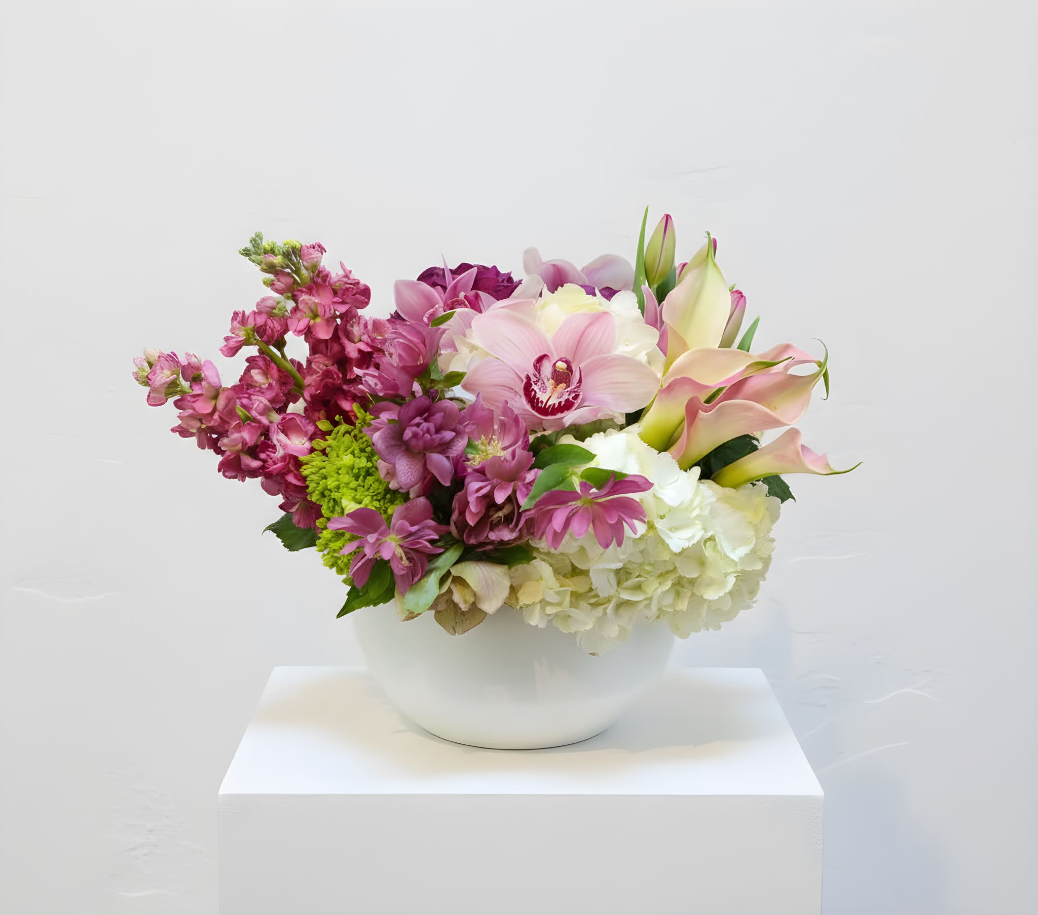 Bespoke Premium Flowers - This is a low centerpiece featuring a variety of pink, mauve, and white premium flowers.