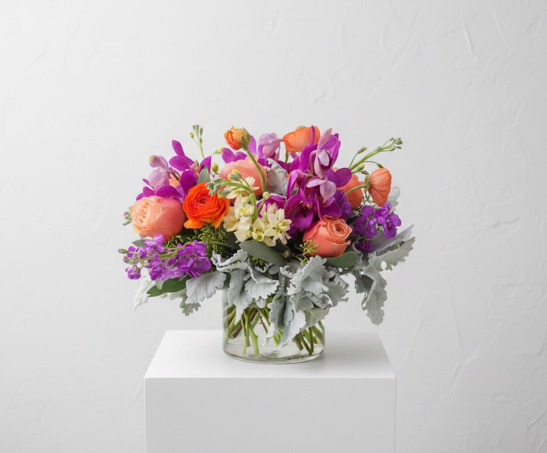 Peachy Keen - This arrangement is a new design using peaches, oranges and purples. The foliage adds a delicate touch with grey undertones.