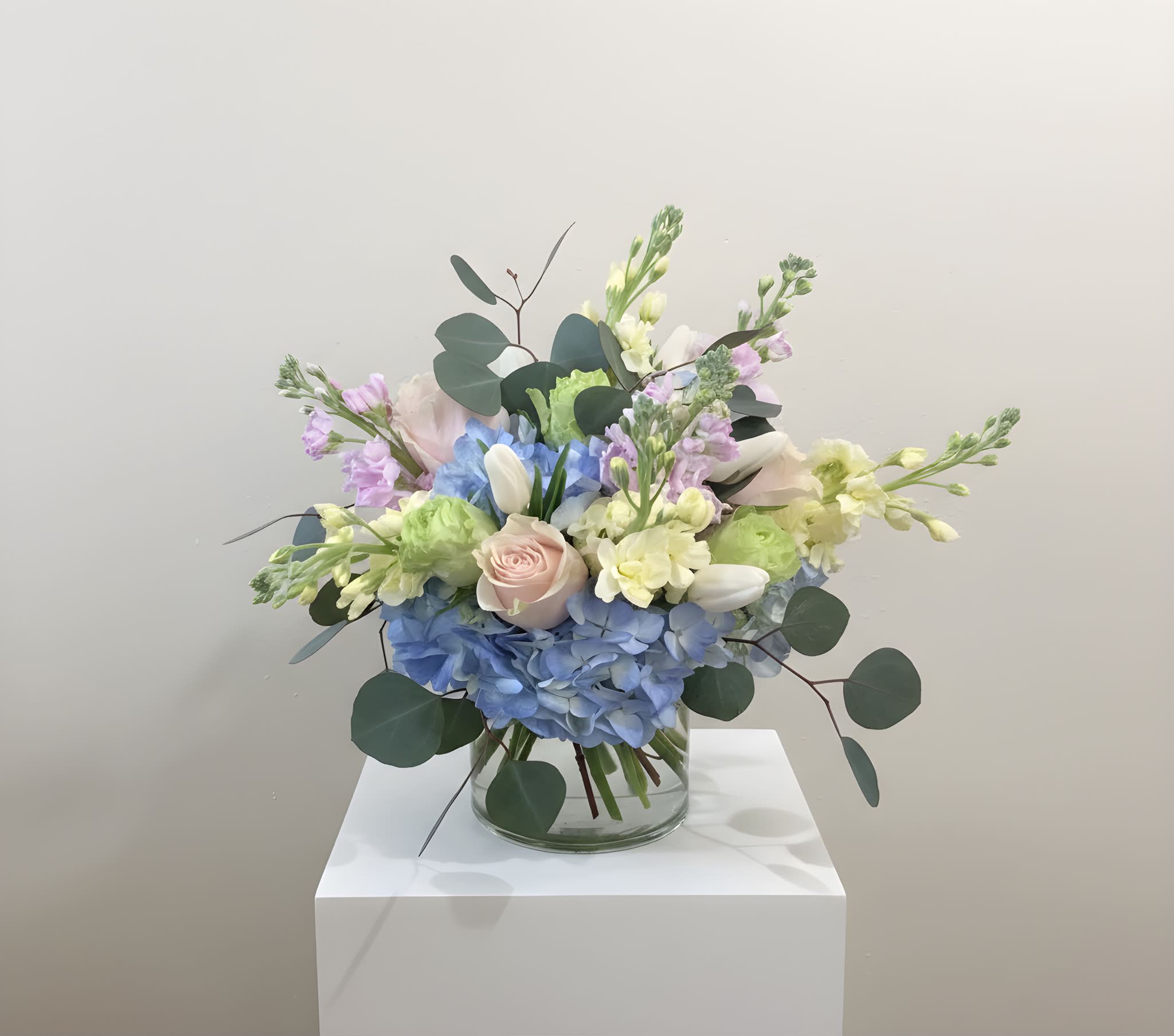Watercolor Garden - Designed in a glass cylinder, this arrangement highlights the calming properties of pastel tones