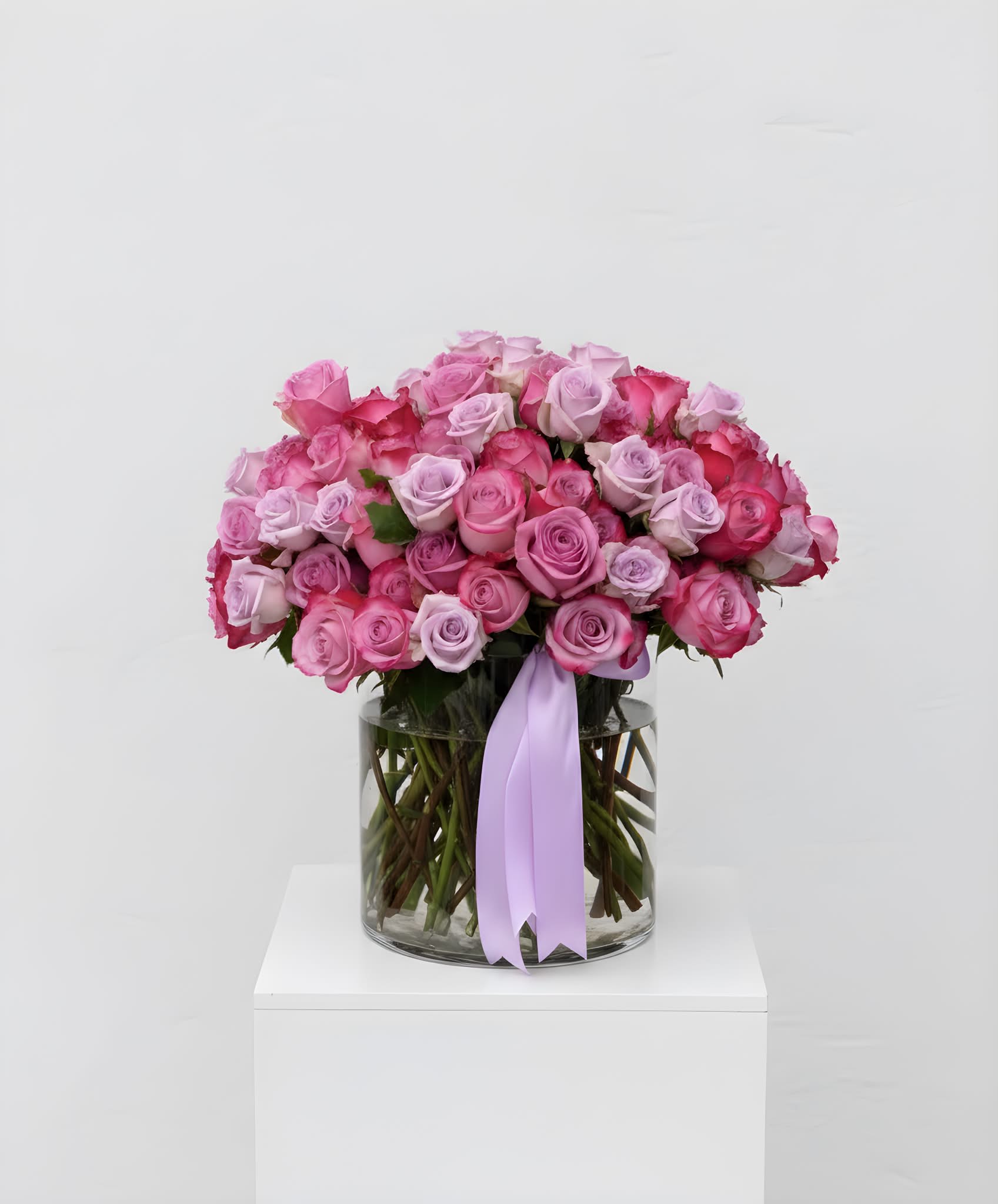 100 Luxury Roses - This arrangement features a variety of imported, premium roses arranged in a large glass vase. Please specify the color of your choice upon ordering.