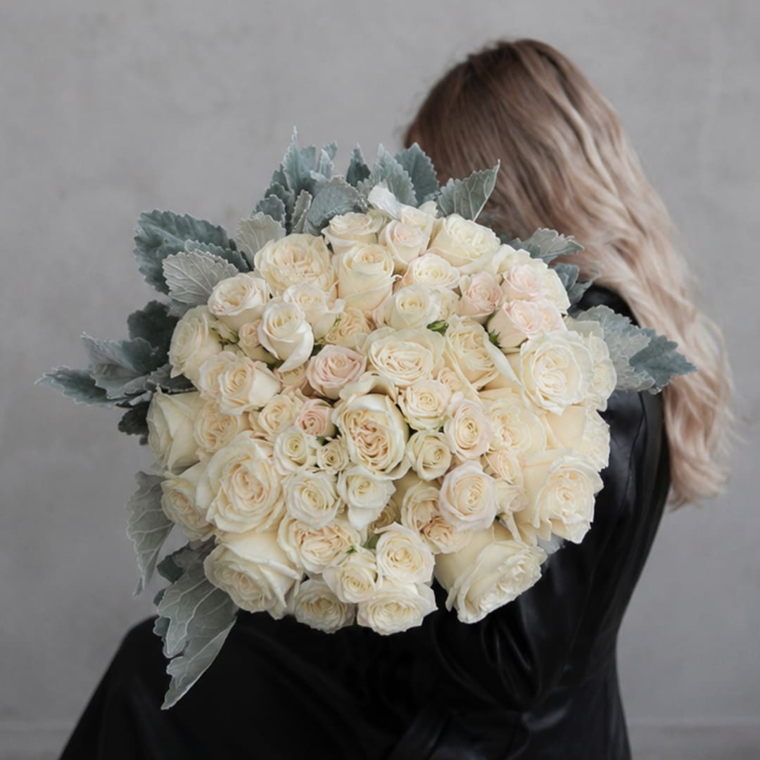 Large bouquet of cream roses with silvery foliage