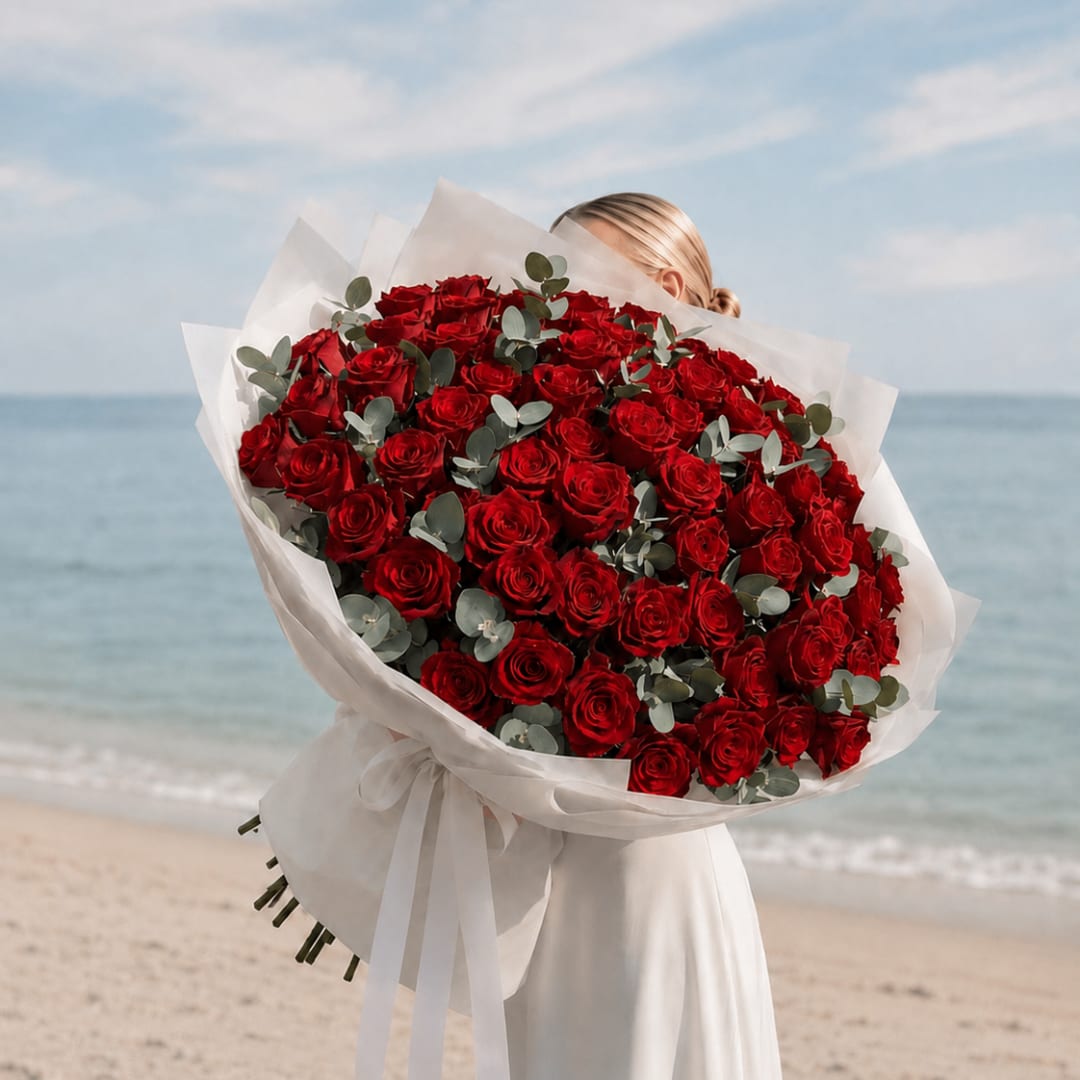 Large bouquet of red roses wrapped in white paper