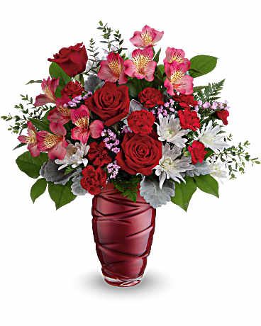 Loving Swirls - Honor the beauty of true love with this vibrant Valentine's Day bouquet of red roses, beautifully arranged in pearlescent glass vase with an eye-catching swirling design. 