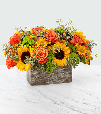 Orange roses and sunflowers arranged in a rectangular box