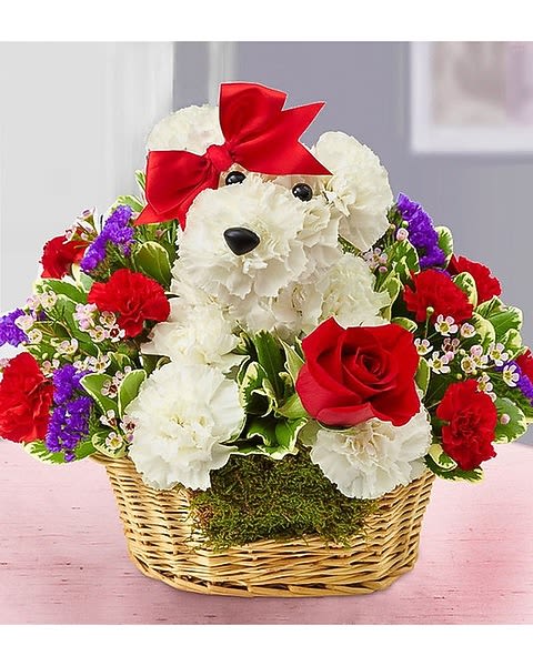 Teddy bear made of white flowers in a basket with red roses and a red bow