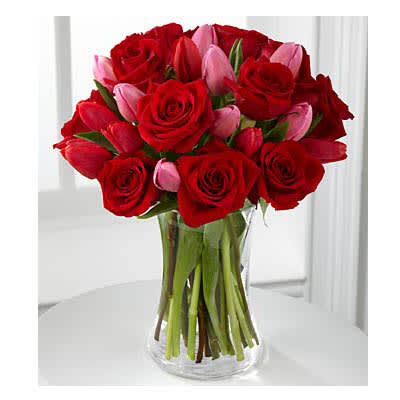 Let Love In - Picked fresh from the farm, the Let Love In Bouquet speaks of romantic moments through rich color and fresh dazzling blooms. Our finest red roses mingle with bright red and popping pink tulips picked fresh from the farm to create the perfect way to win their heart. BEST bouquet includes 22 stems with vase. Bouquet is approximately 16"H x 13"W.