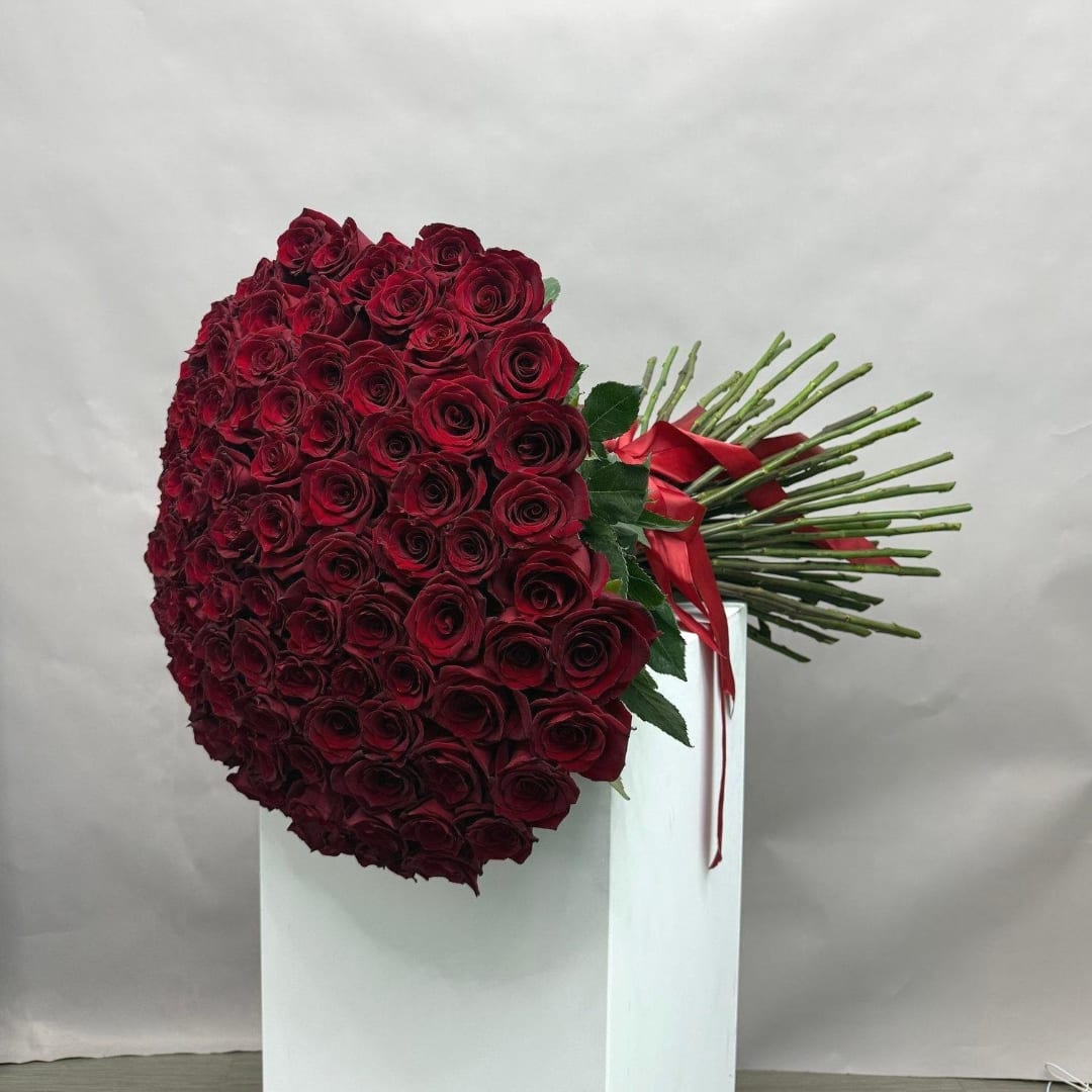 Large bouquet of deep red roses tied with a red ribbon