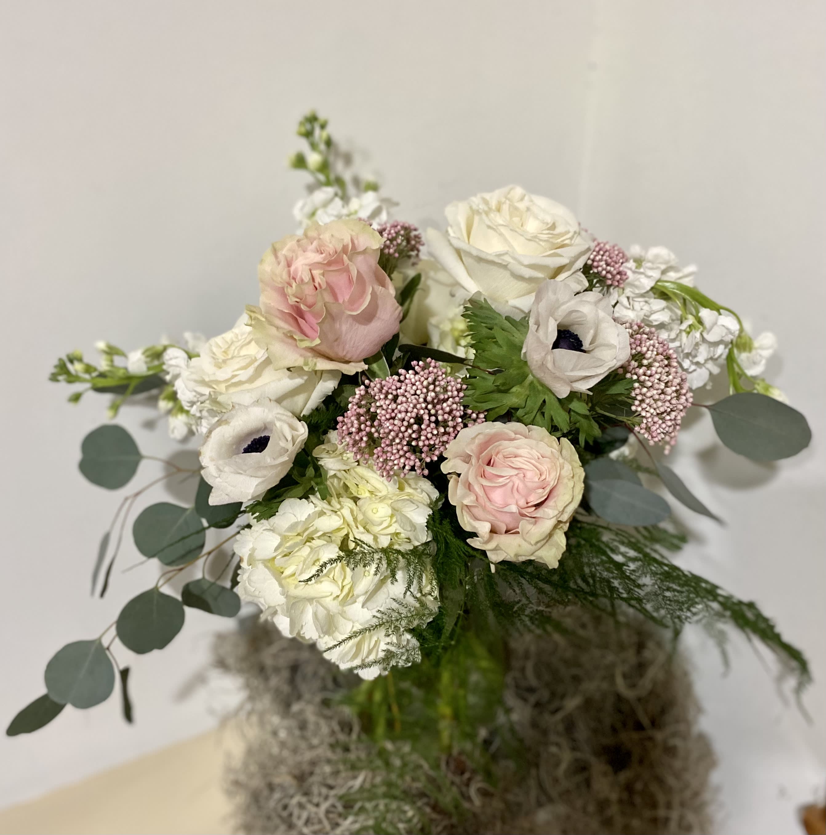 Bouquet of blush and white flowers with round eucalyptus leaves