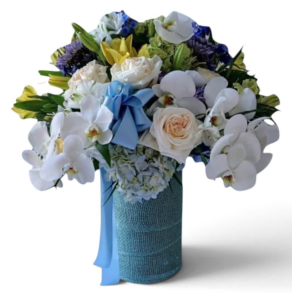 Bouquet of white orchids, roses, and mixed blooms in a blue-wrapped vase