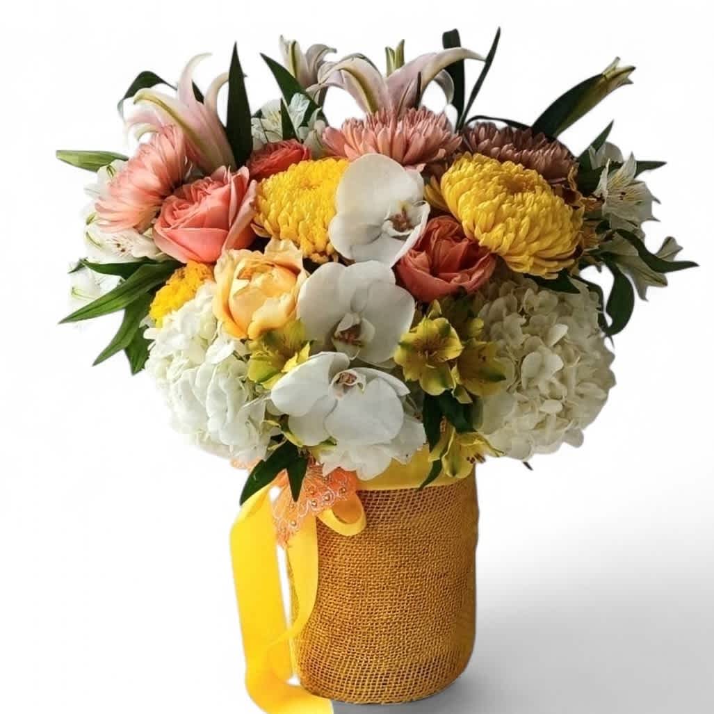 Mixed bouquet with orchids, roses, hydrangeas, and chrysanthemums in a burlap-wrapped vase