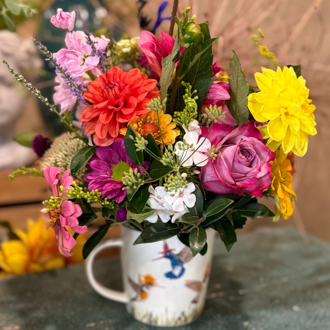 Colorful mixed bouquet in a white mug vase