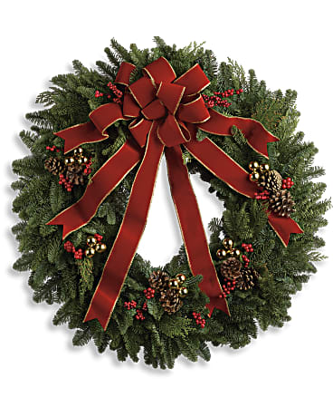 Christmas wreath with a red bow, pinecones, and red berries