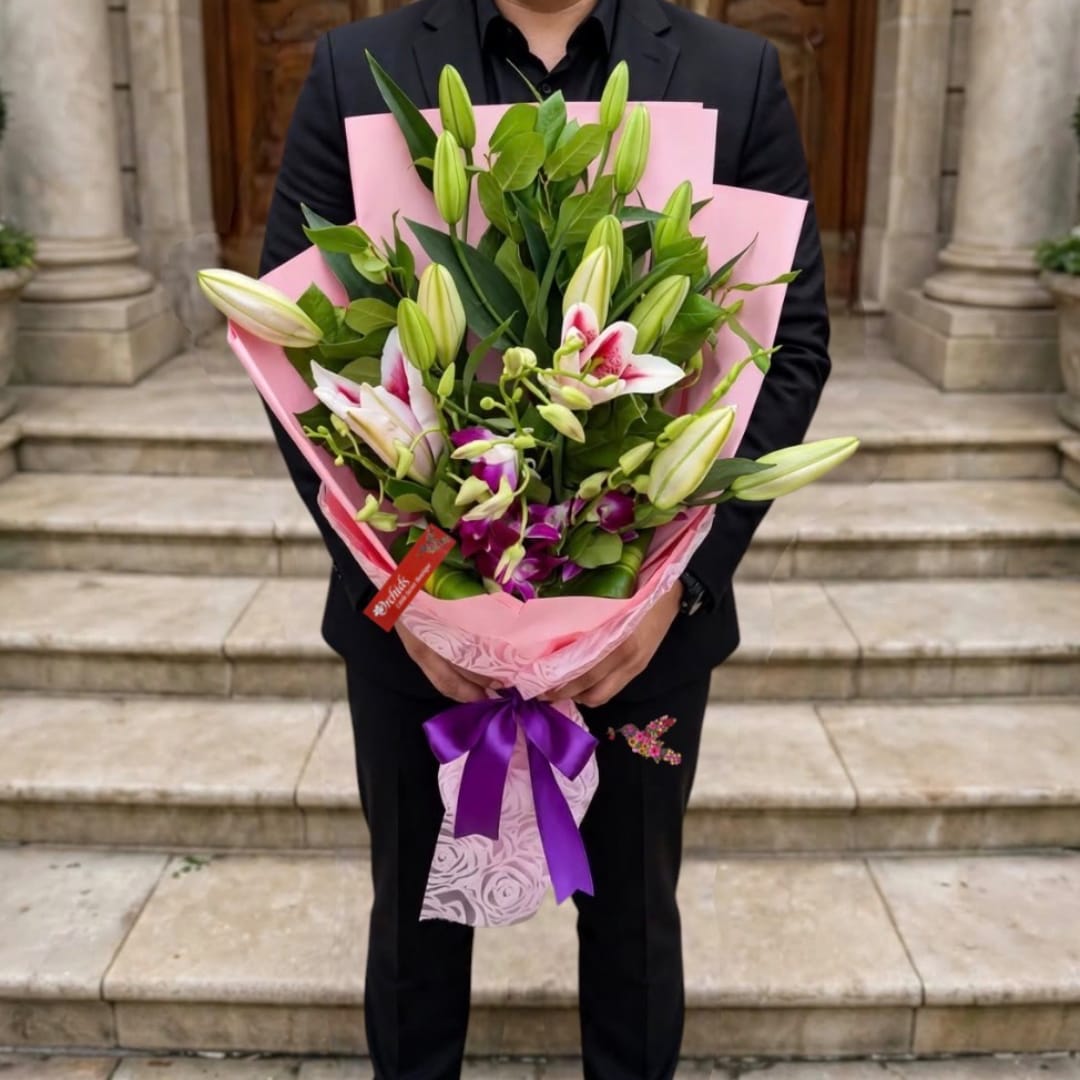 Person holding a bouquet of lilies wrapped in pink paper
