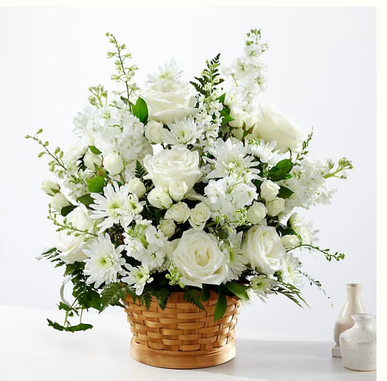 Heartfelt Condolences Arrangement - Let this exquisite composition of beautiful white blossoms deliver your sympathy and comfort loved ones grieving a loss. The elegance of this arrangement and its warm, homey basket base makes it an appropriate addition to any wake, funeral or graveside service, or to send to the home of family or friends.