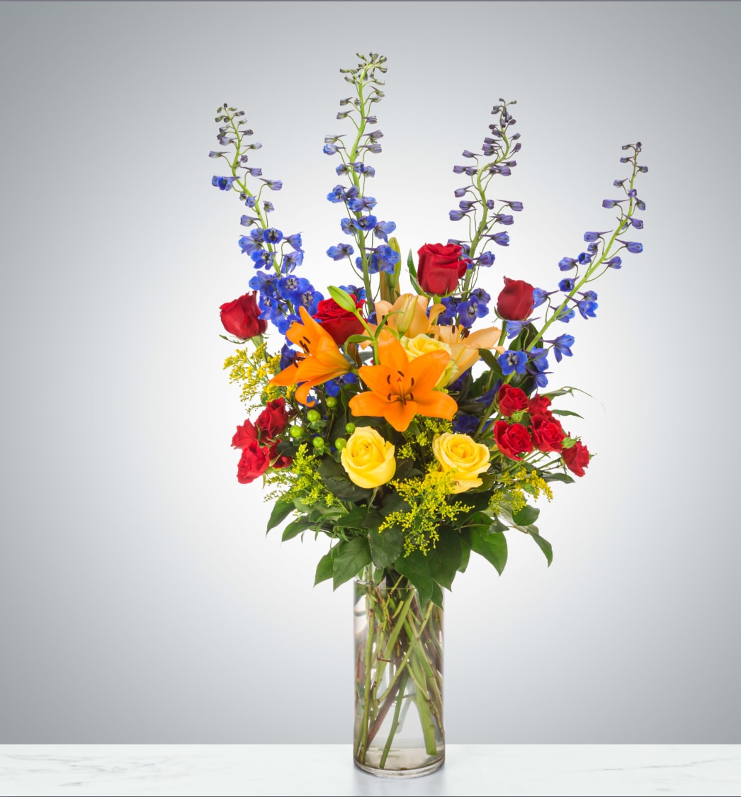 Ravishing Rainbow  - A full rainbow of colors in this arrangement makes it a perfect arrangement to send to brighten up any space. A tall vase and height-defying flowers make it a great option for lifting someone's spirits.  Approximate Dimensions: 16"D x 32"H