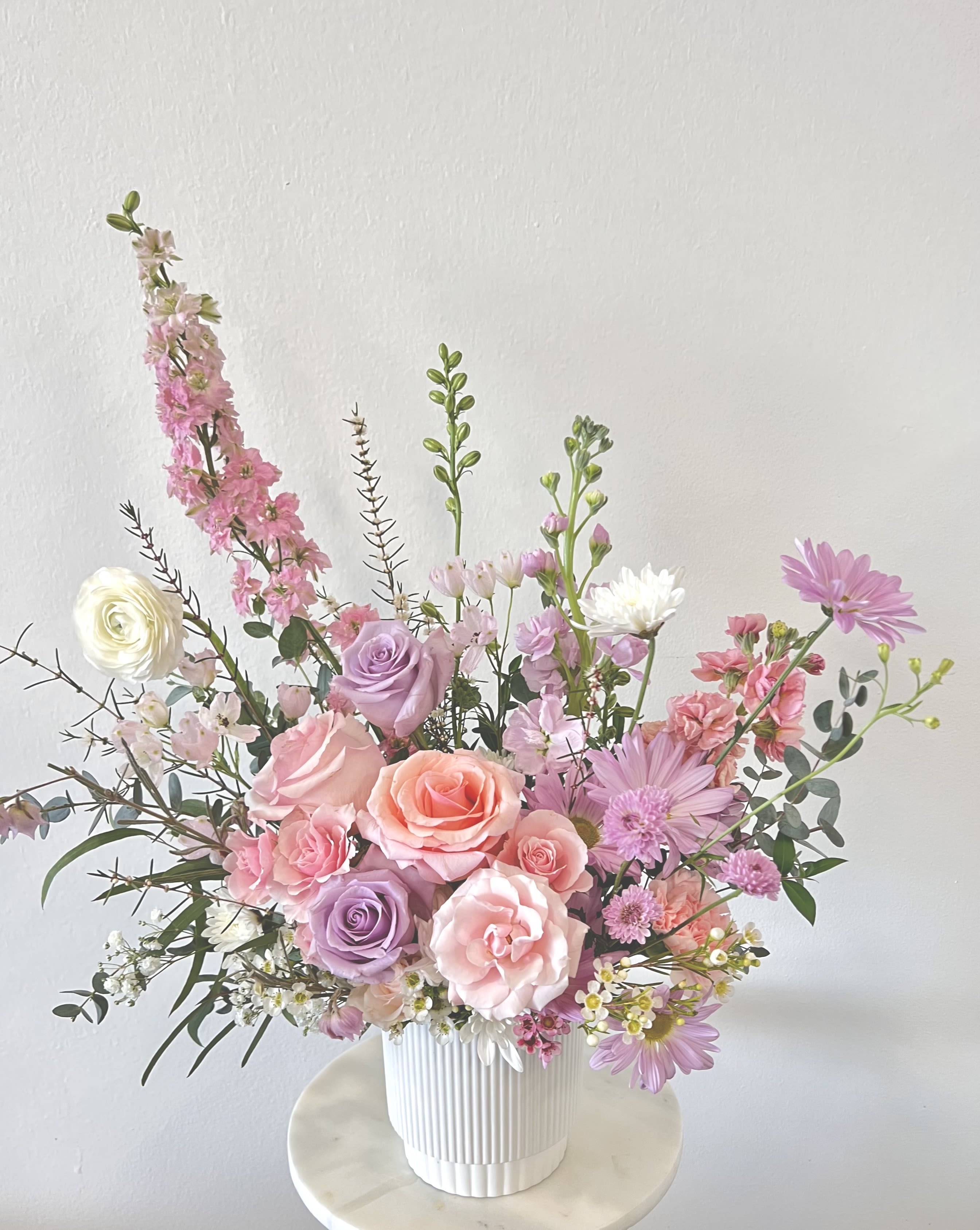 Spring Elegance  - Vase Arrangement  Store Hours Mon–Fri: 9:30 a.m. – 6:00 p.m. Sat: 9:00 a.m. – 4:00 p.m. Sun: Closed  Delivery Deliveries are typically made between 9:00 a.m. and 3:00 p.m. While we are unable to guarantee specific delivery times, we will always do our best to accommodate your requests. If you prefer a later afternoon delivery, please let us know in advance and we will try to accommodate. If your delivery address requires a gate code, please provide it to ensure smooth delivery.  Pick-Up If you need to pick up before 9:30 a.m., please text us directly to place your order. (Text: 714-715-1482) Please also try to pick up your order at the scheduled time. When pick-ups are delayed during busy time slots, it may affect other customers placing orders for the same time. We appreciate your understanding!  Please Note Your arrangement may vary slightly from the photos depending on seasonal availability and store stock. However, we will match the overall color palette and ensure your flowers are fresh and beautifully designed.  Thank you!!