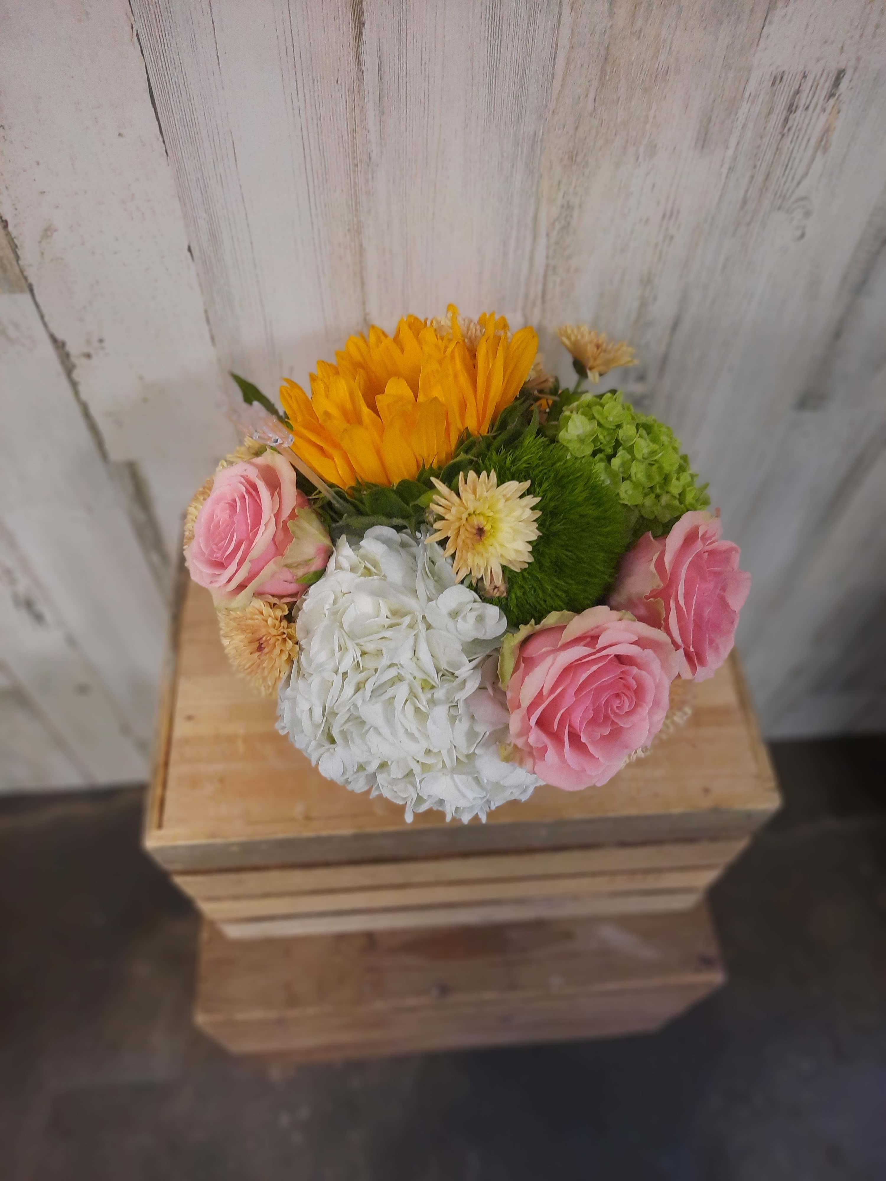 Mixed bouquet with pink roses, white hydrangea, and orange blooms