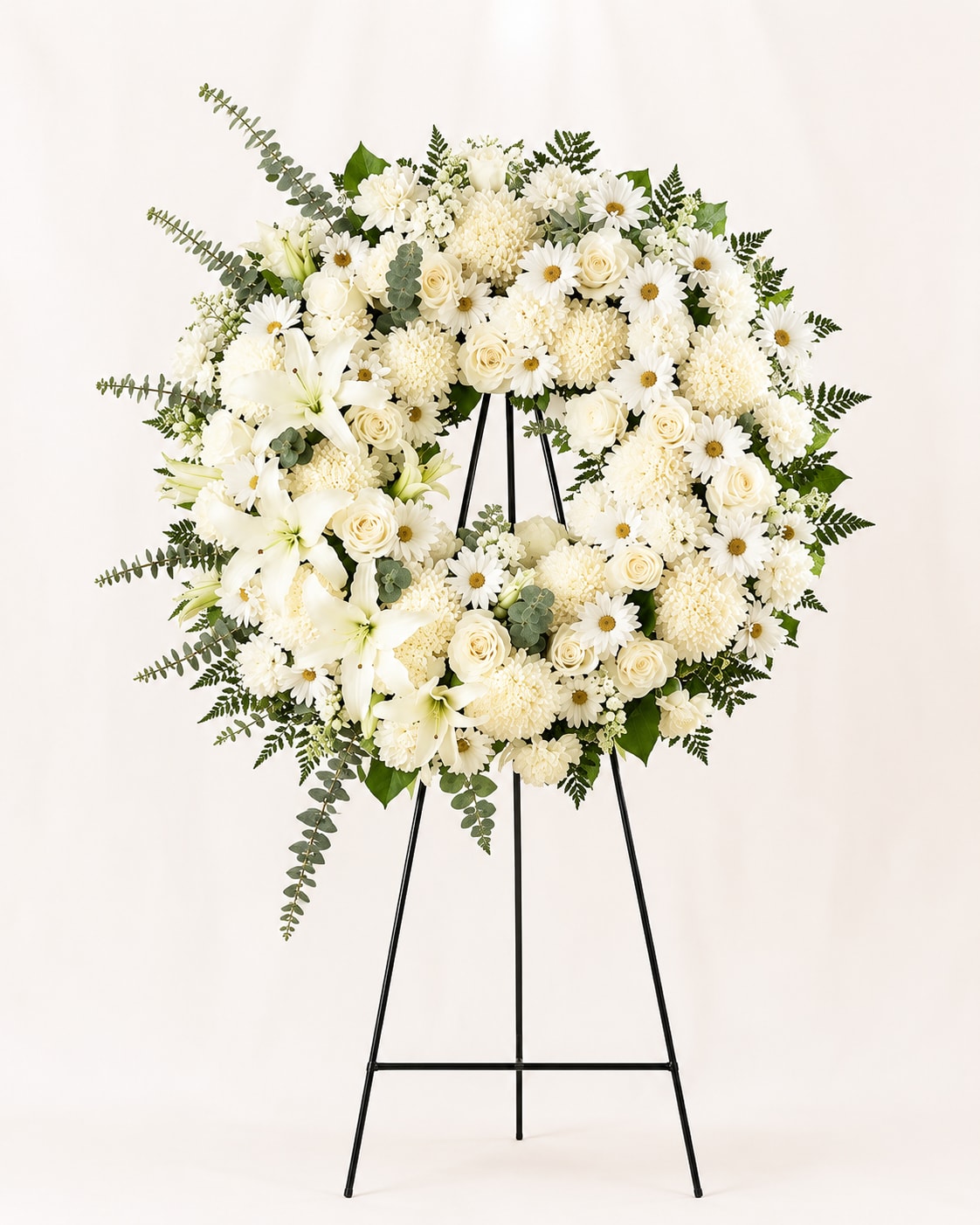 Grace Wreath - Pure and peaceful arranged, the Heavenly Grace Wreath offers a timeless expression of love, remembrance, and eternal serenity. Lush greenery and touch of eucalyptus add depth and gentle movement, giving the wreath a natural, refined presence that feels both uplifting and comforting. Designed for funeral and memorial services, this all-white tribute speaks with quiet dignity and conveys heartfelt sympathy when words alone cannot express enough. 
