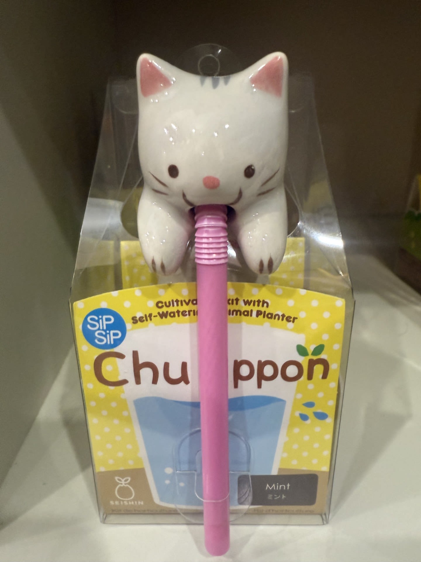 Cat-shaped plant watering spike in retail packaging