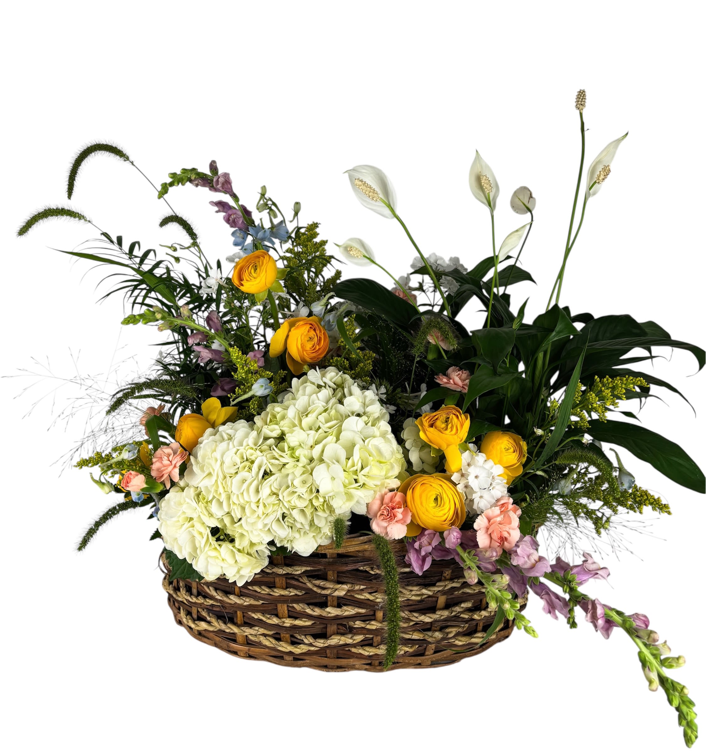 Low basket arrangement with white hydrangeas, yellow blooms, peach flowers, and tall white peace lilies.