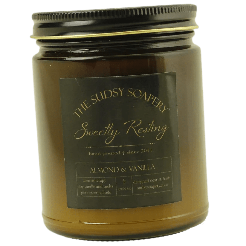 Amber jar candle with a black lid and label