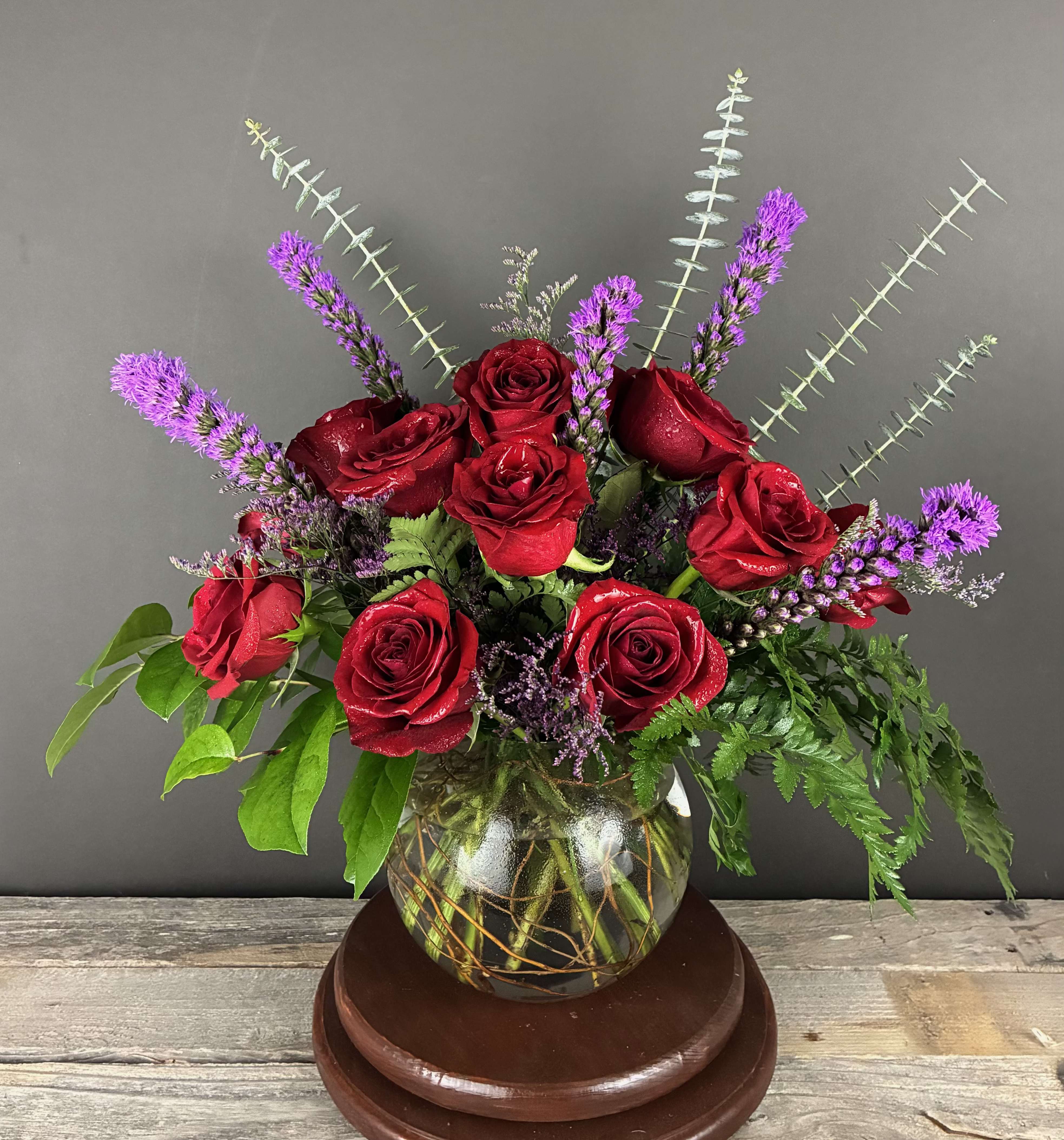 Lucious Love - Stunning red roses and purple liatris in a bubble vase. Show your love with this classy arrangement! To ensure we have the correct color of roses on hand, please order no sooner than 48 hours before your desired delivery date.