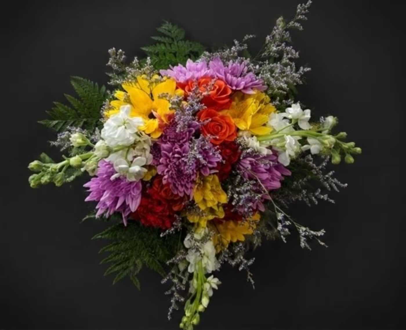 Summer Blooms Wrapped Bouquet - A lush, rounded celebration of color, this flower arrangement is a joyful summer bouquet perfect for birthdays, congratulations, or just because. The mixed-color Summer Blooms Bouquet brings together roses and large chrysanthemum-like blooms with stock and airy white filler to create an energetic, festive display that reads as both cheerful and sophisticated-ideal when you want the person you're thinking of to feel noticed and celebrated.