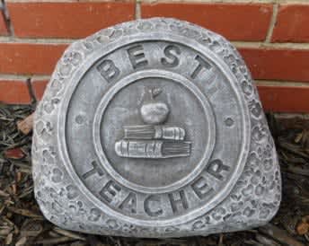 Stone plaque reading "Best Teacher" with an apple and books emblem