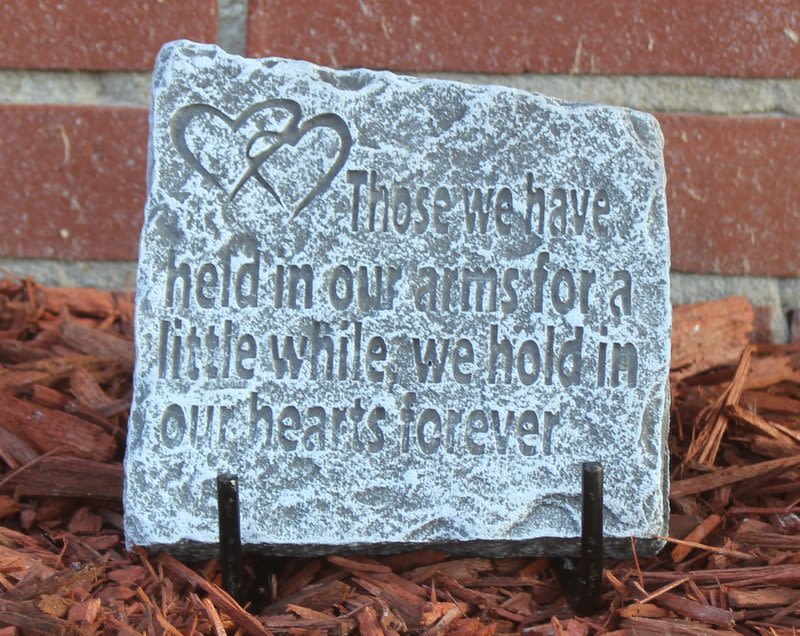 Decorative stone plaque with a heart design and engraved memorial quote