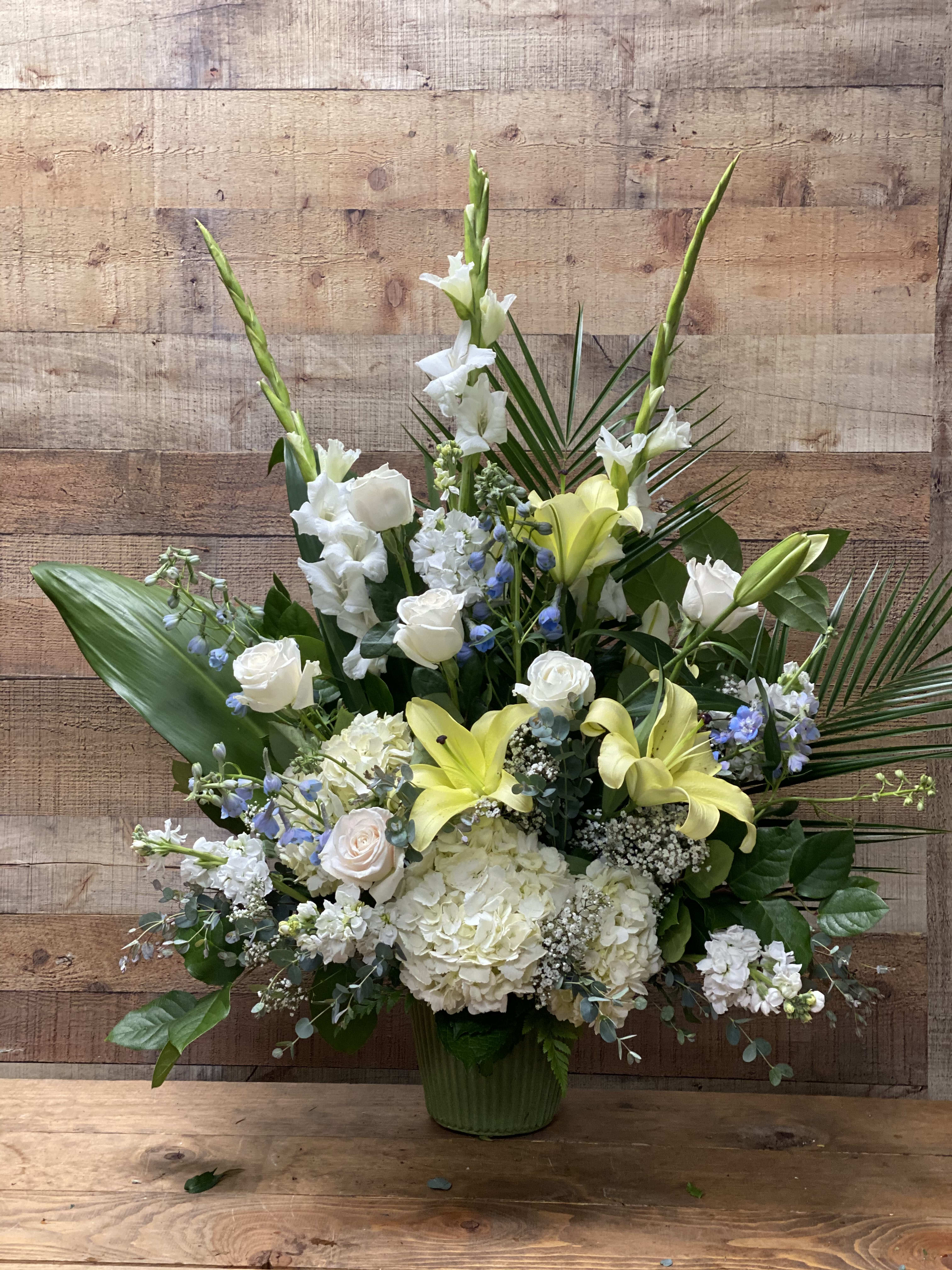 Faithful Garden Bouquet - A beautiful arrangement for a service or to send to the home, with an assortment of gladiolas, lilies, roses, hydrangea, blue delphinium and baby's breath.
