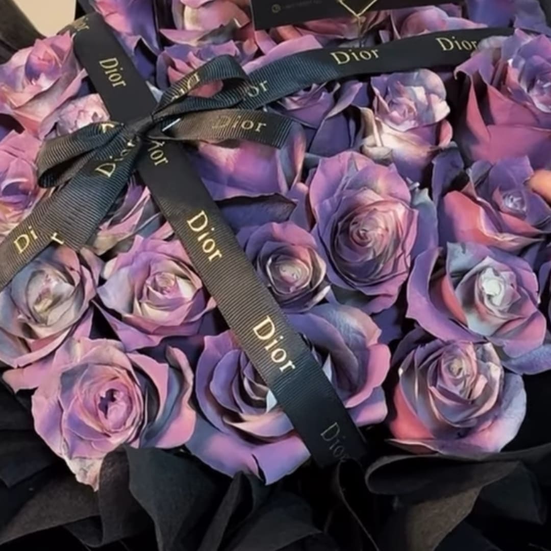 Purple and pink roses tied with black Dior ribbons