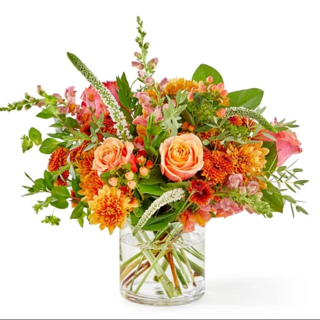 Orange and pink bouquet in a clear glass vase