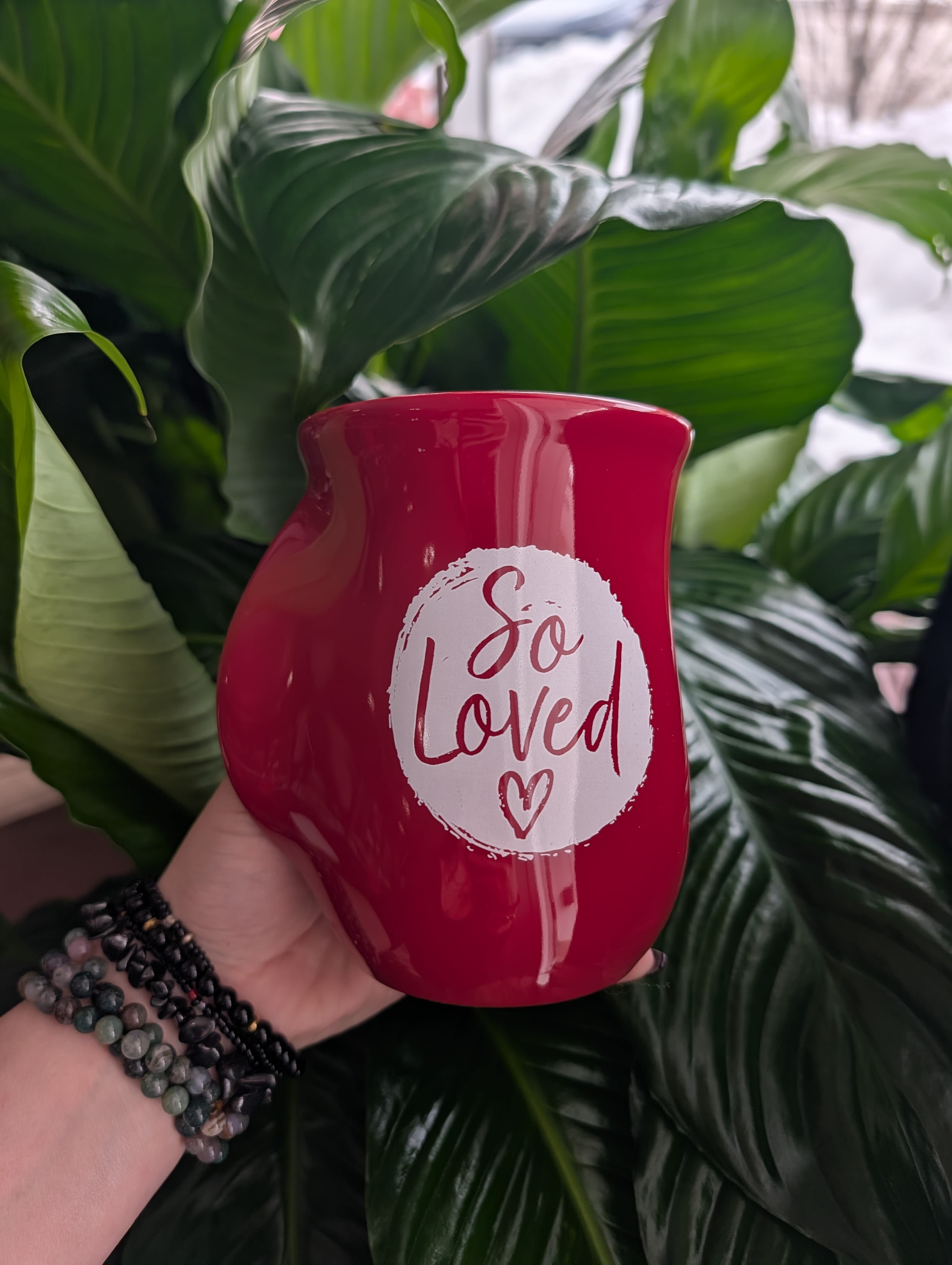 Red memorial candle holder with "So Loved" text
