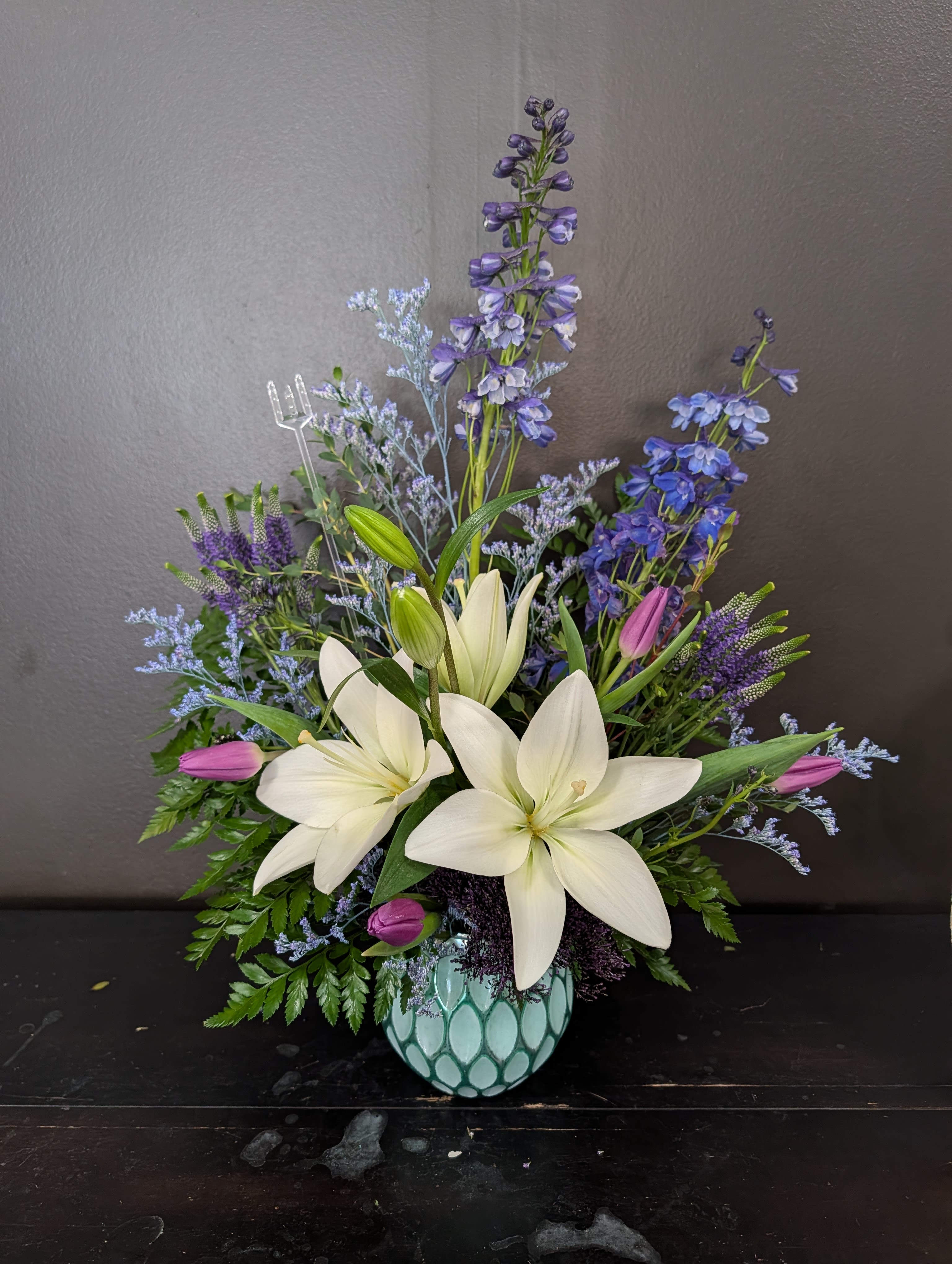 Shimmering Waters - A blue, white and purple arrangement in a reflective textured vase