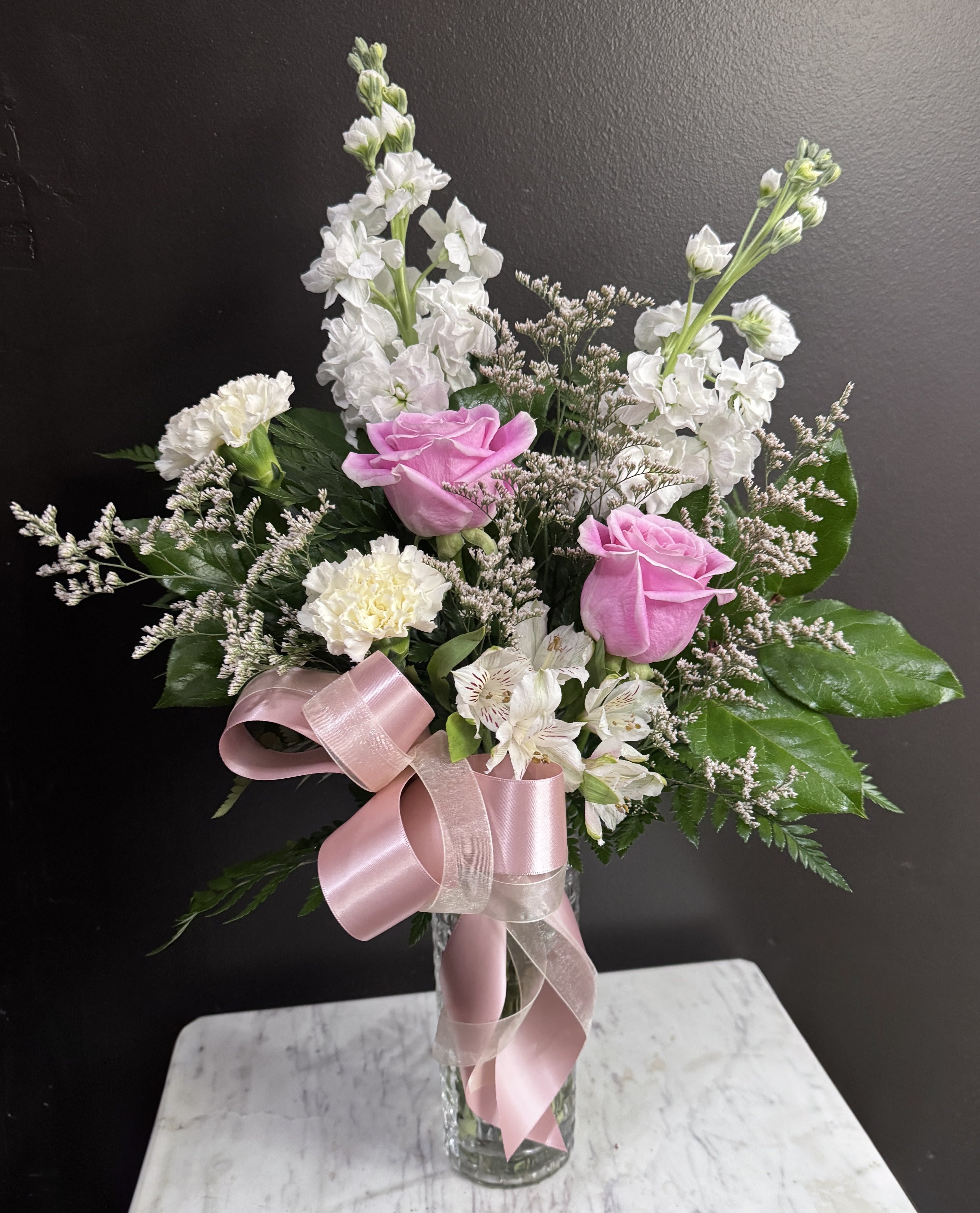 Pretty Pinks - For the pink lover in your life, pink and white blooms in a basket style vase.