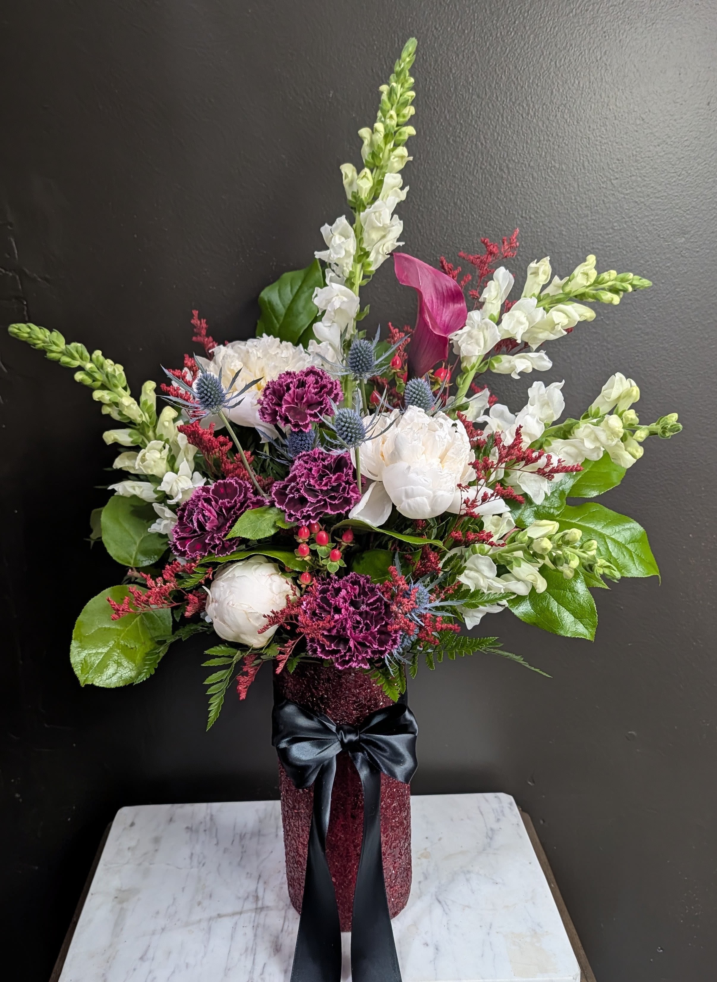 Black Tie Attire - A classy Moody arrangement with reds, purples, and black satin.