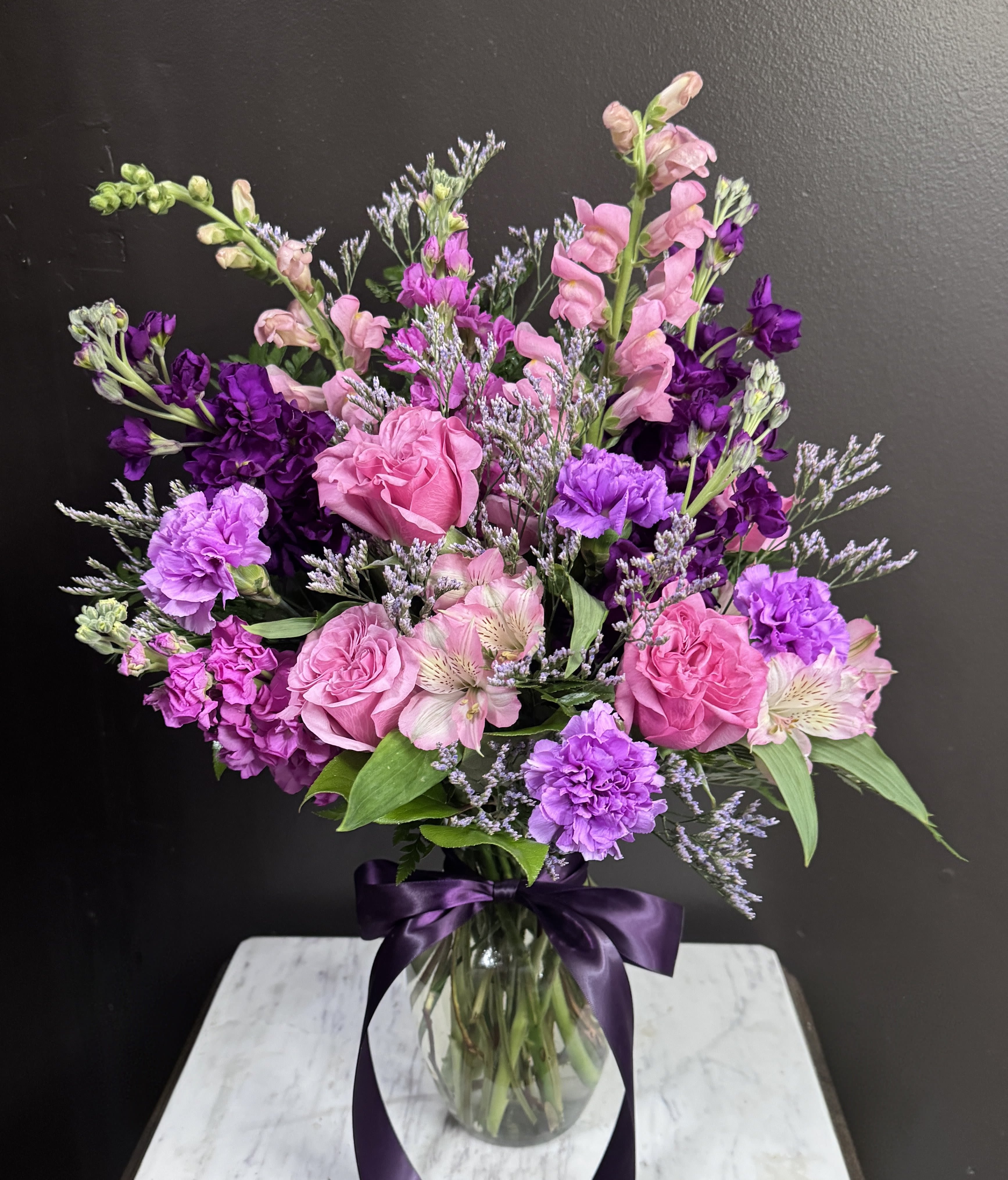 Cha-Cha Real Smooth - Beautiful pink and purple blooms in a clear glass vase for any occasion.