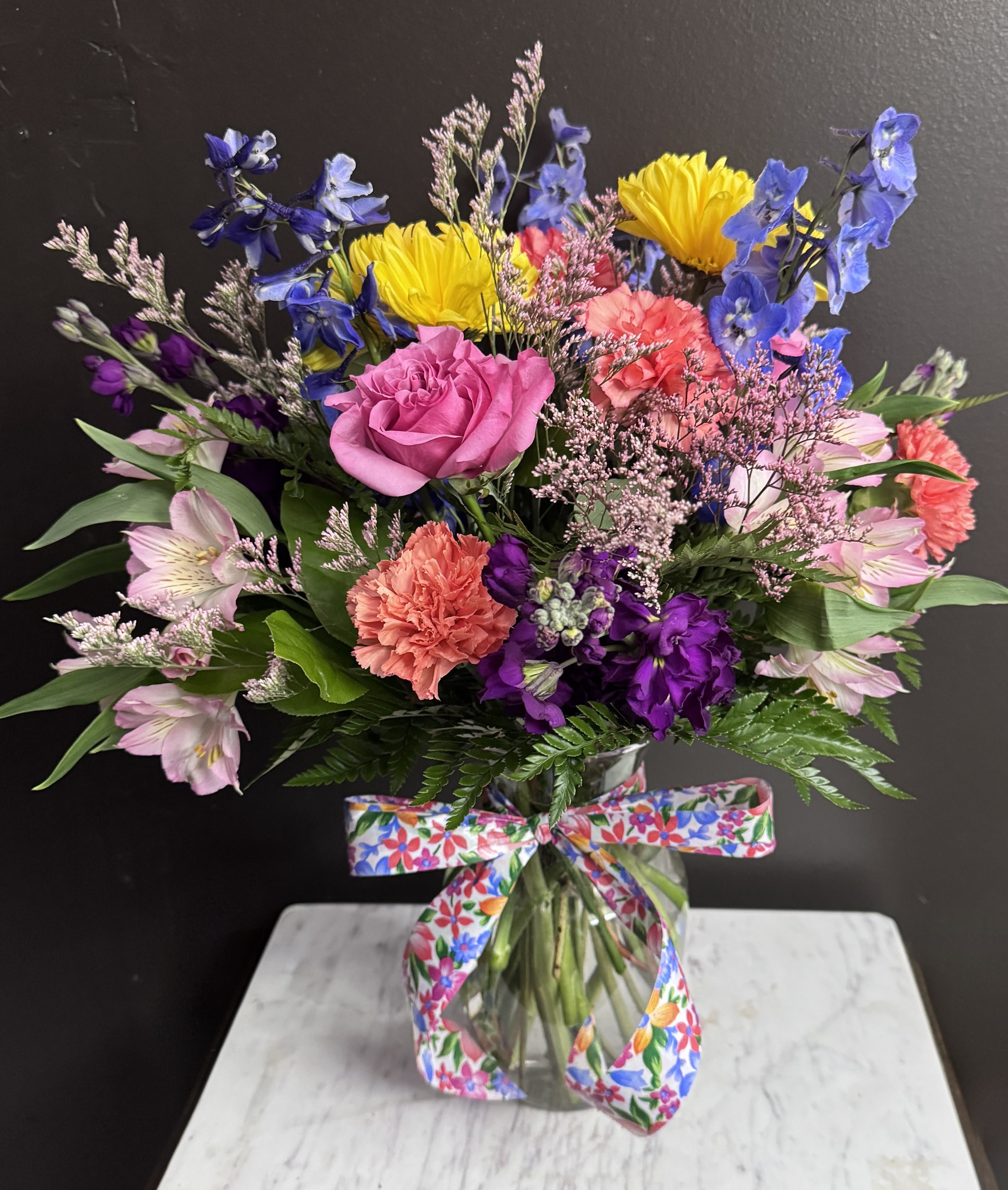 Cheers To You - Cheery bright blooms ina clear glass vase.