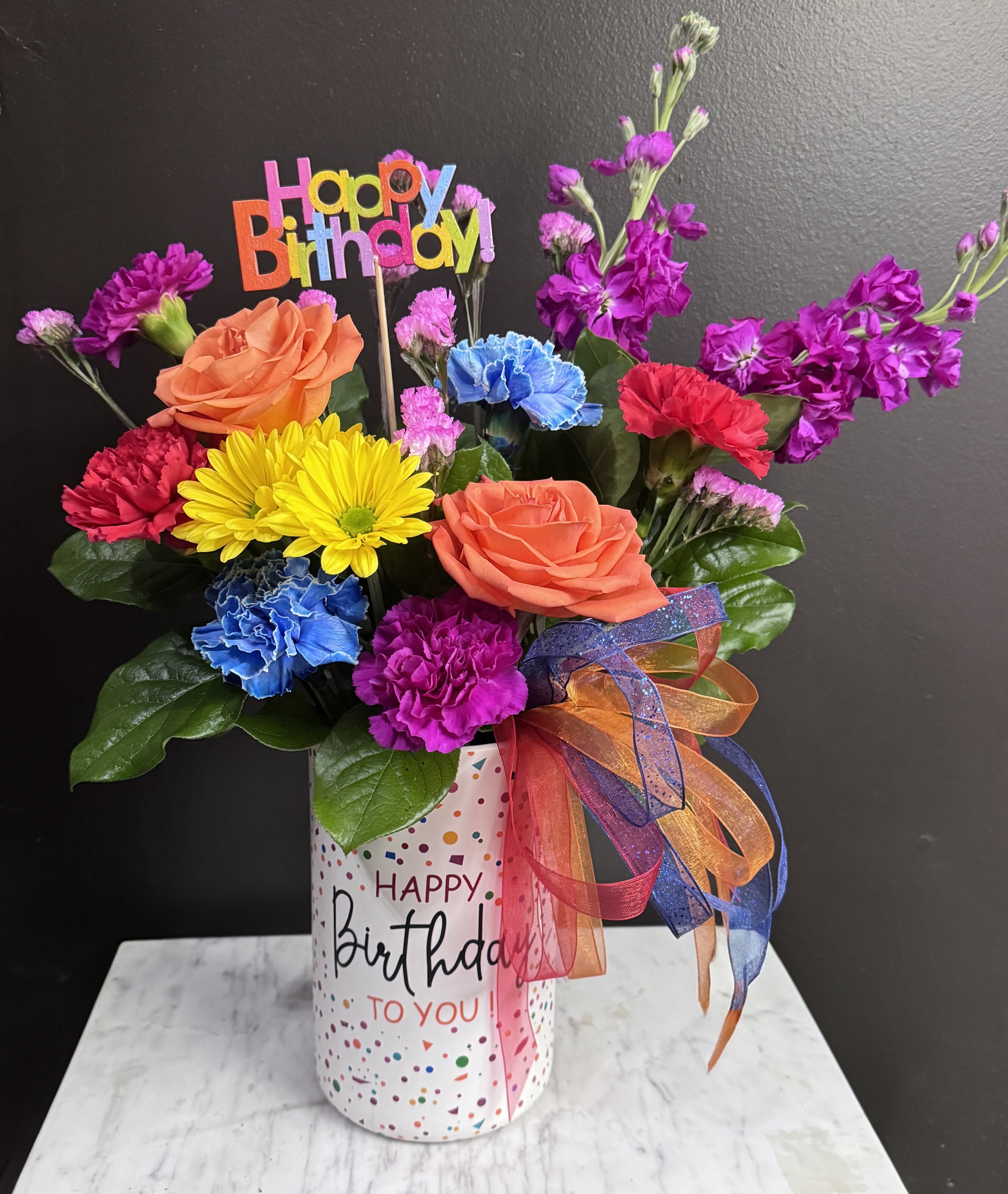 Happiest Birthday - A bright arrangement that screams HAPPY BIRTHDAY!! in a birthday keepsake vase with a birthday pick included.