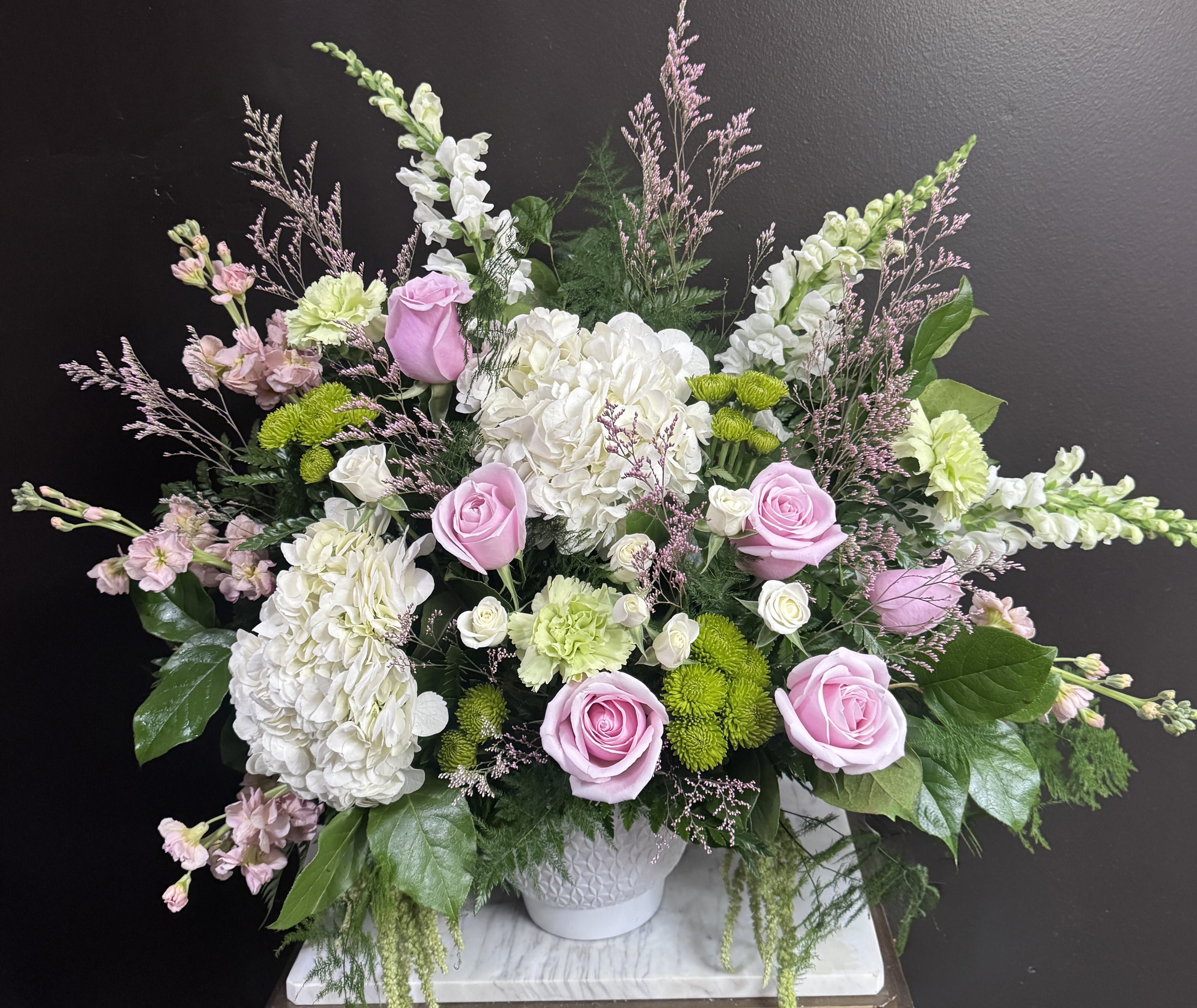 Grand Gesture Floor Basket - Pink, white, and green blooms arranged whimsically in a floor basket.