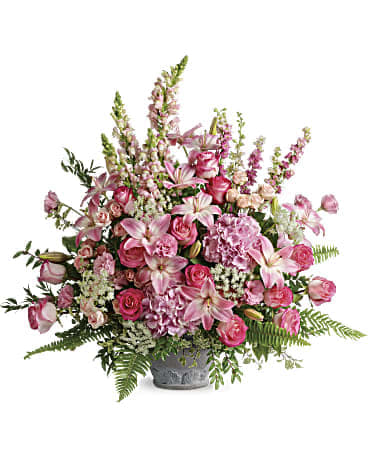 Pink mixed flower arrangement in a gray vase