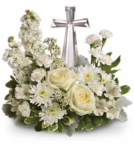 White floral arrangement with roses, daisies, and a silver cross