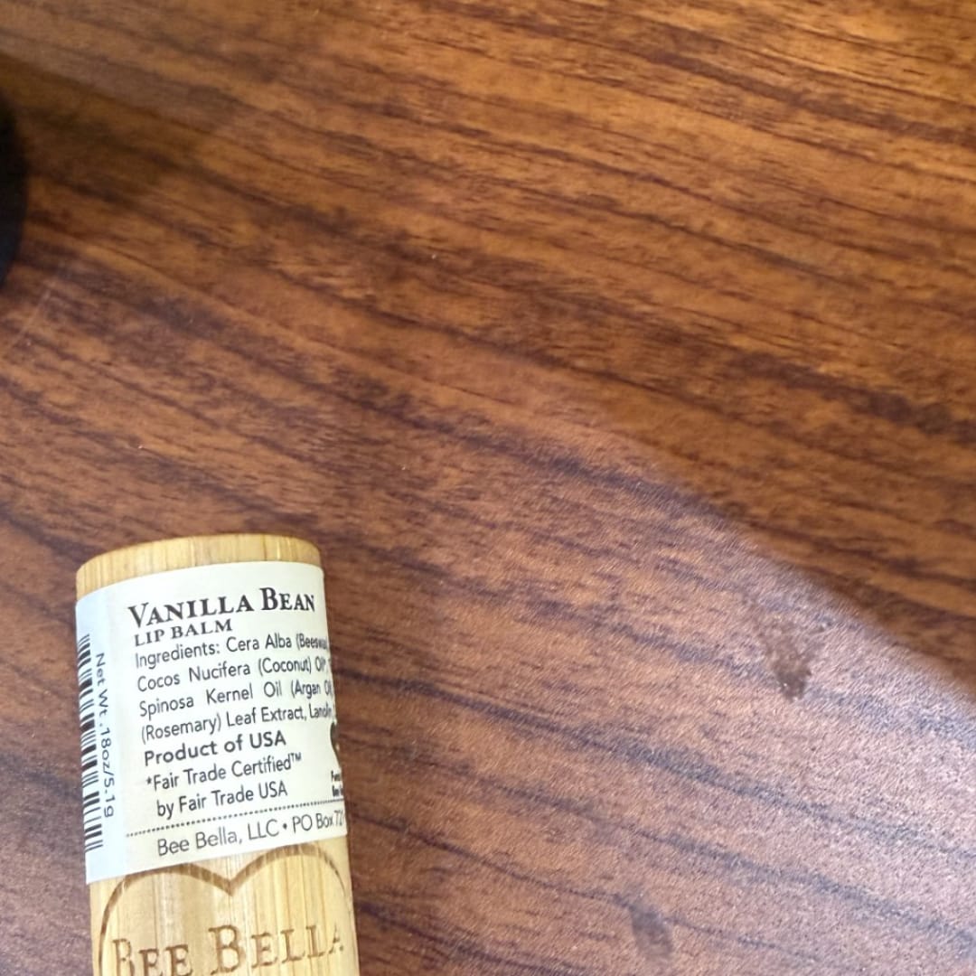 Vanilla Bean lip balm tube on a wooden surface