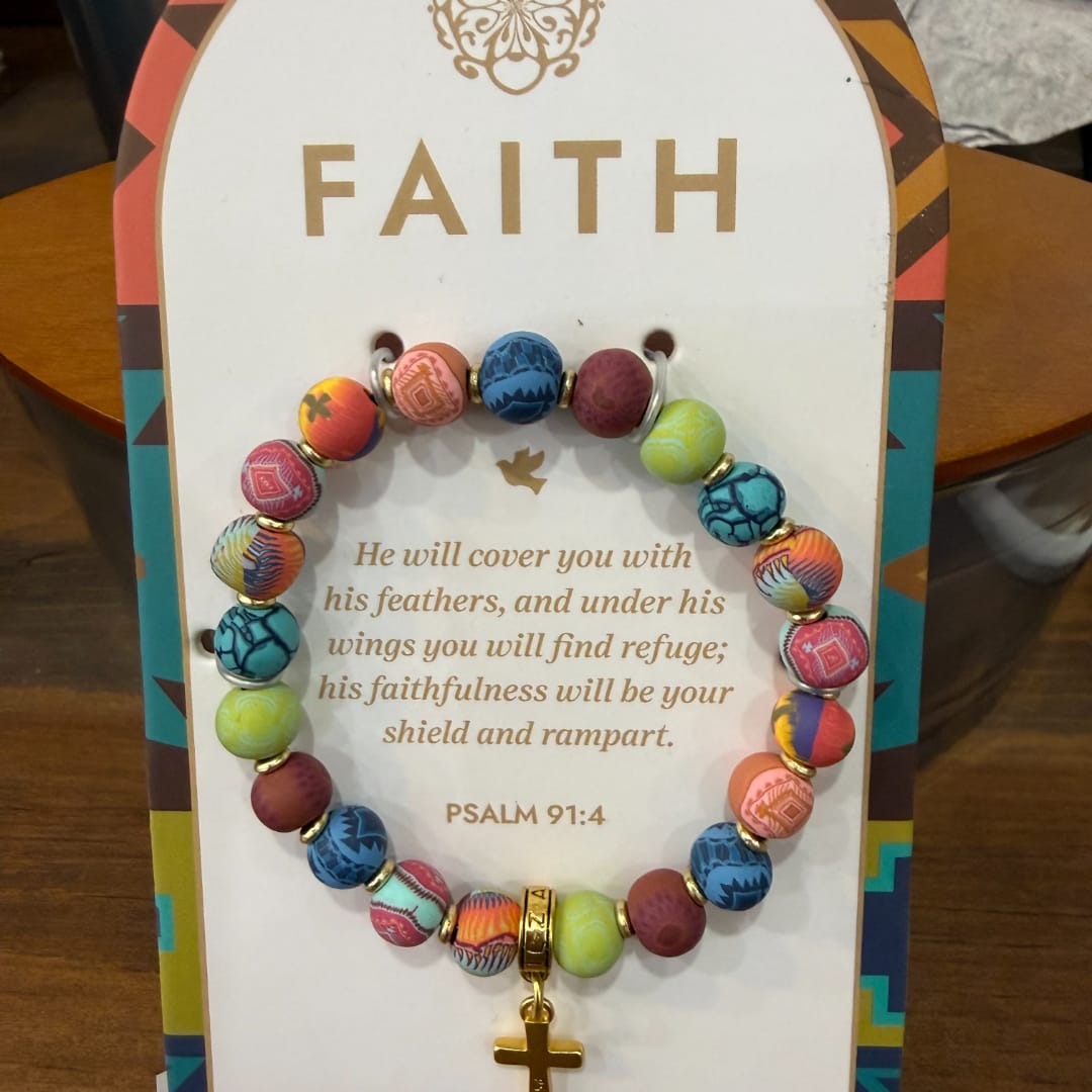 Beaded bracelet with a gold cross charm on a faith card