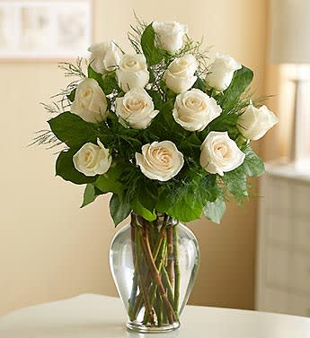 One Dozen White Roses Arranged - One dozen long stem white roses masterfully arranged in a glass vase with mixed greenery.  An arrangement that communicates a pure and lasting message.  We now have less than 2.5 dozen of these remaining.  Order soon to ensure product availability. 